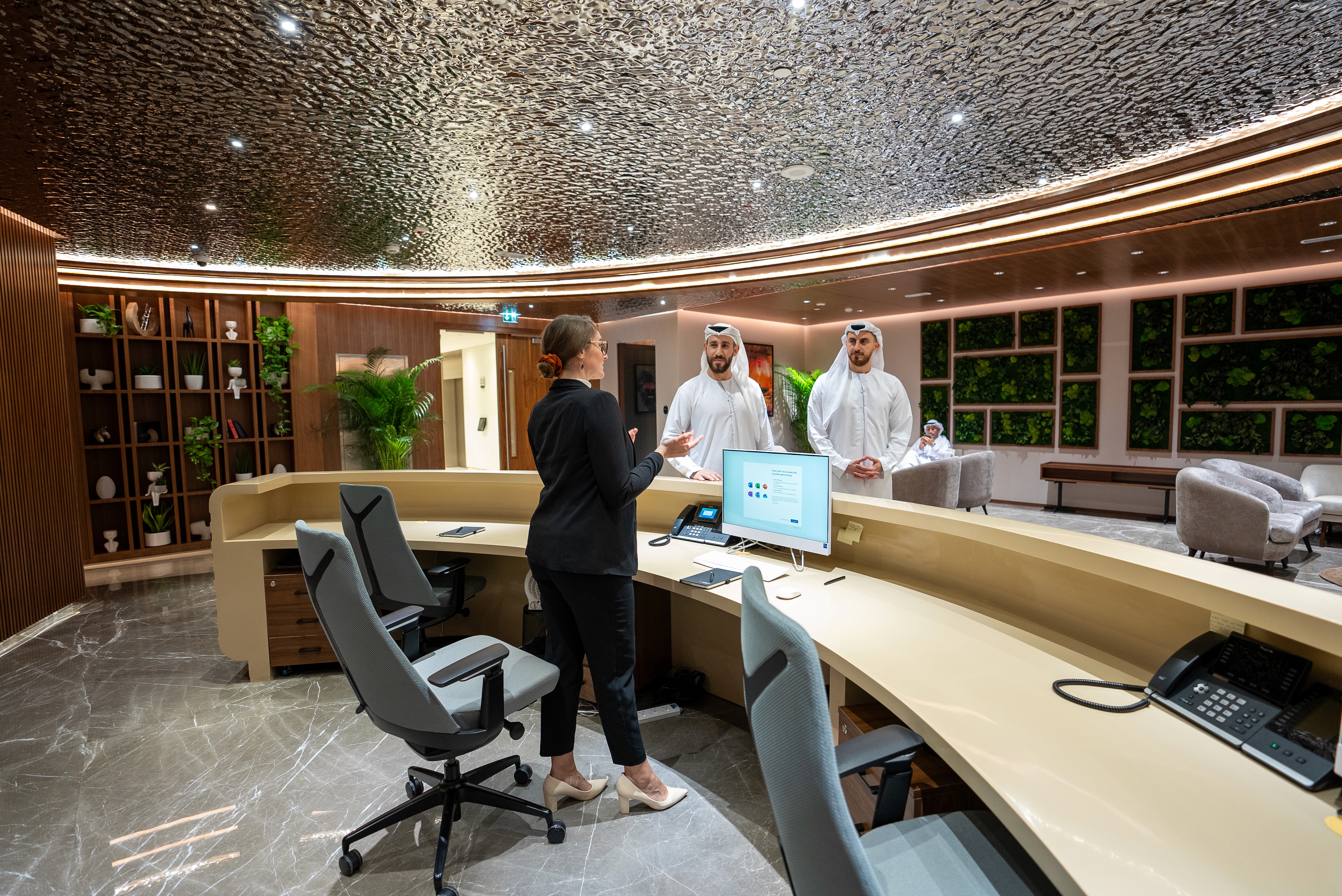 Concierge desk inside a coworking space, with a welcoming atmosphere and executive business lounge.