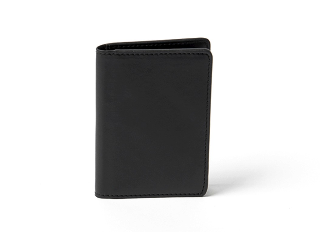 A simple black leather card holder wallet standing upright against a white background.