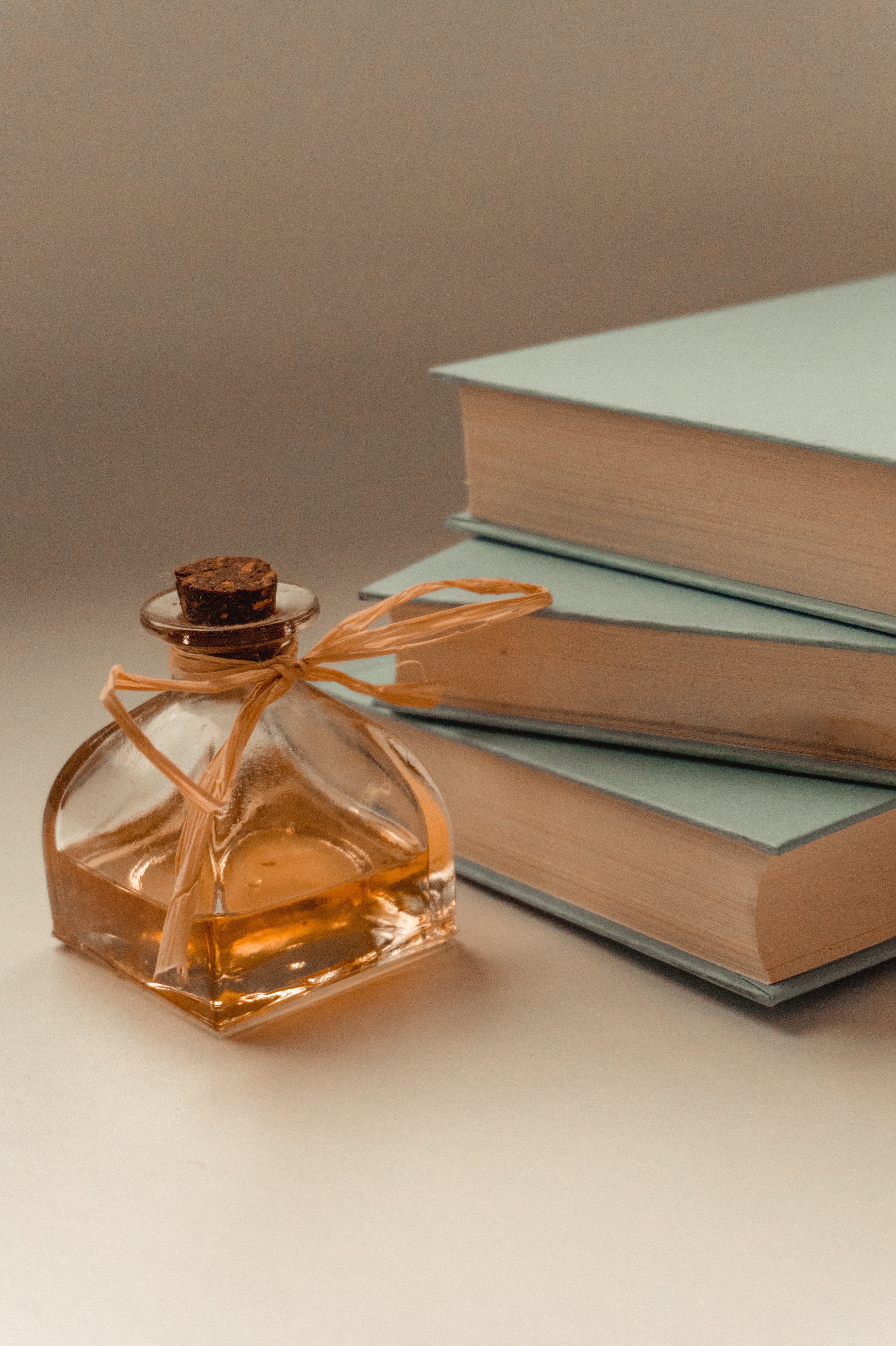 A perfume beside some books