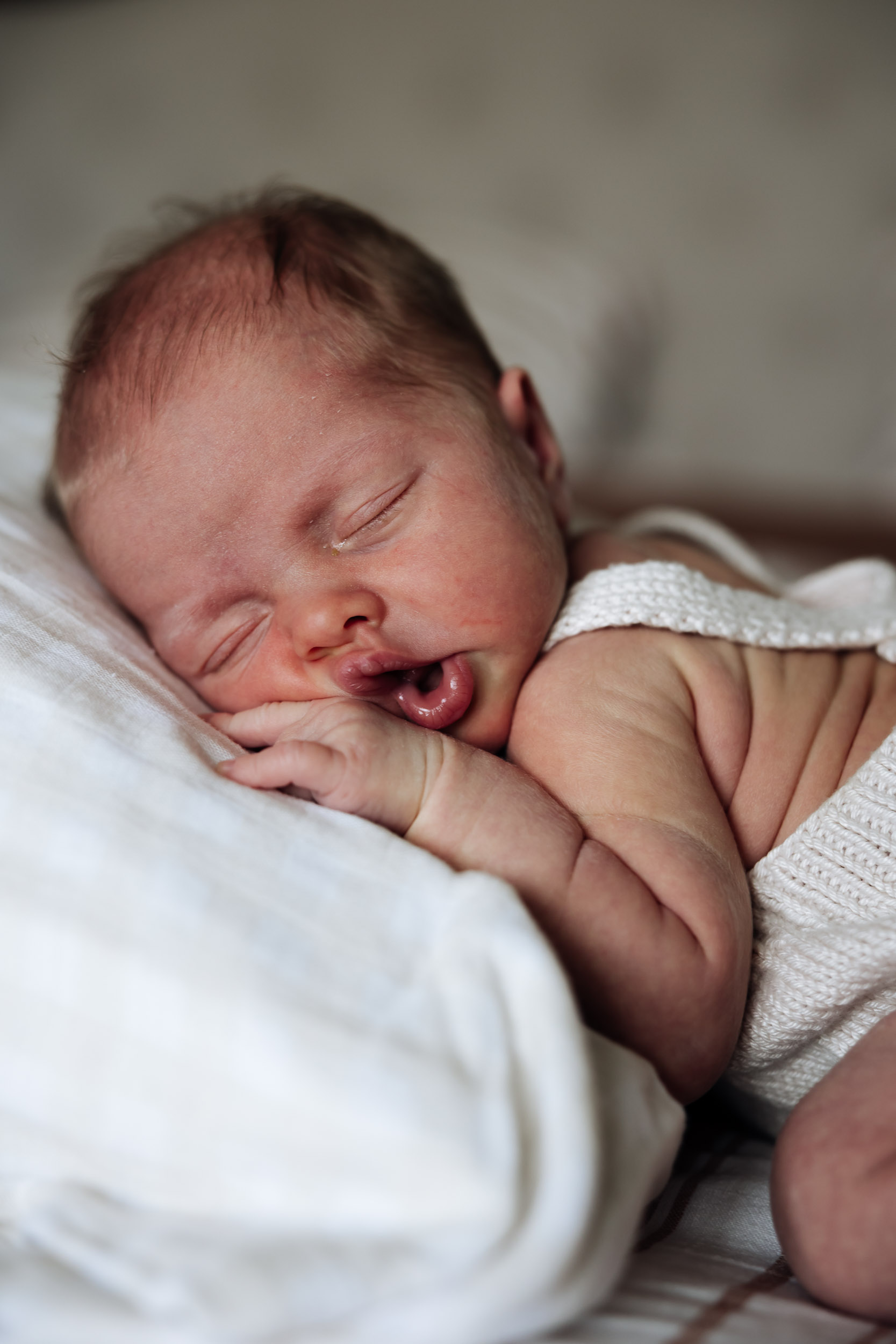 Close up of a newborn baby sleeping on a pillow