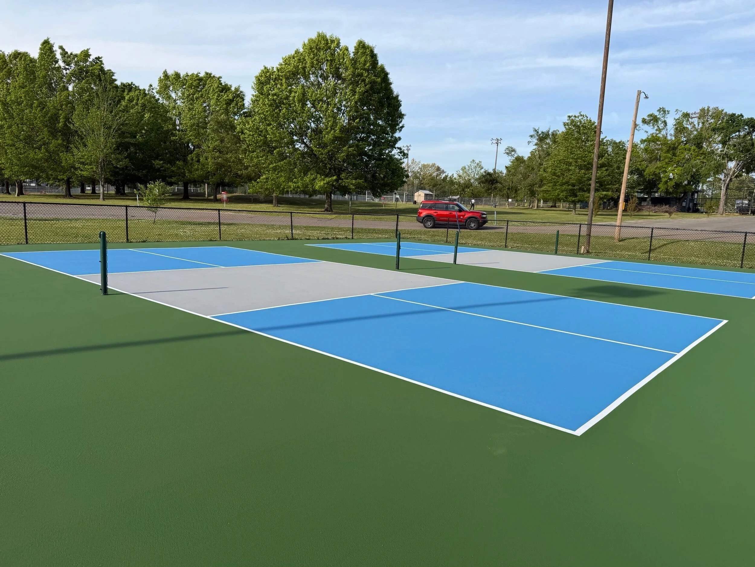 Resurfaced pickleball courts with blue, gray, and green acrylic surfaces at Corinth Parks & Rec in Corinth, MS