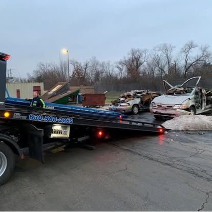 Man wearing a beanie and shirt works on a laptop.