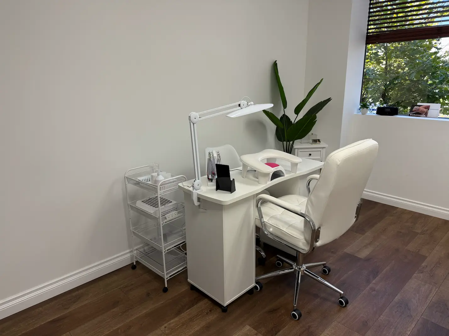Station area with power strip visibly mounted under table