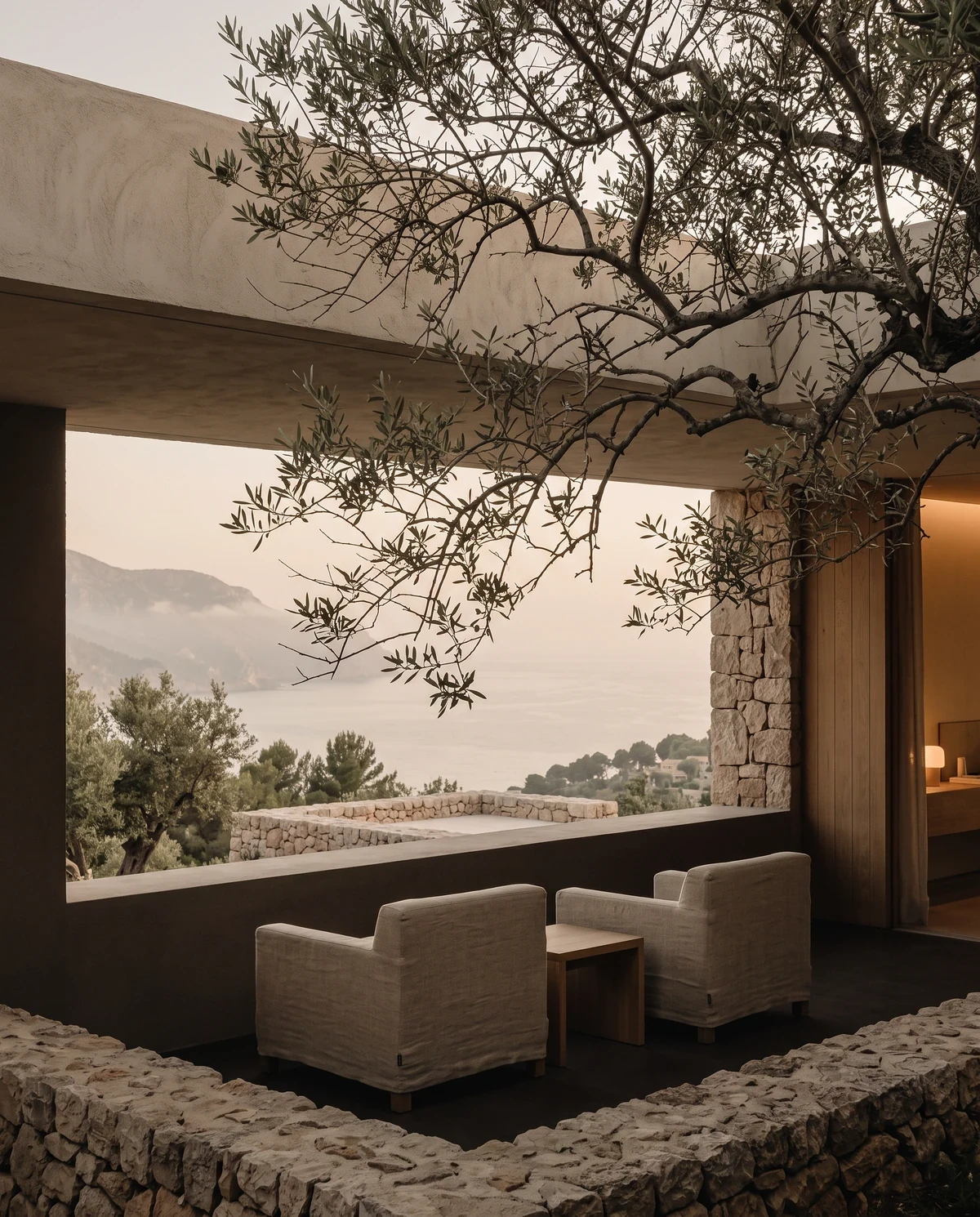 Shaded terrace with linen chairs and a sea view
