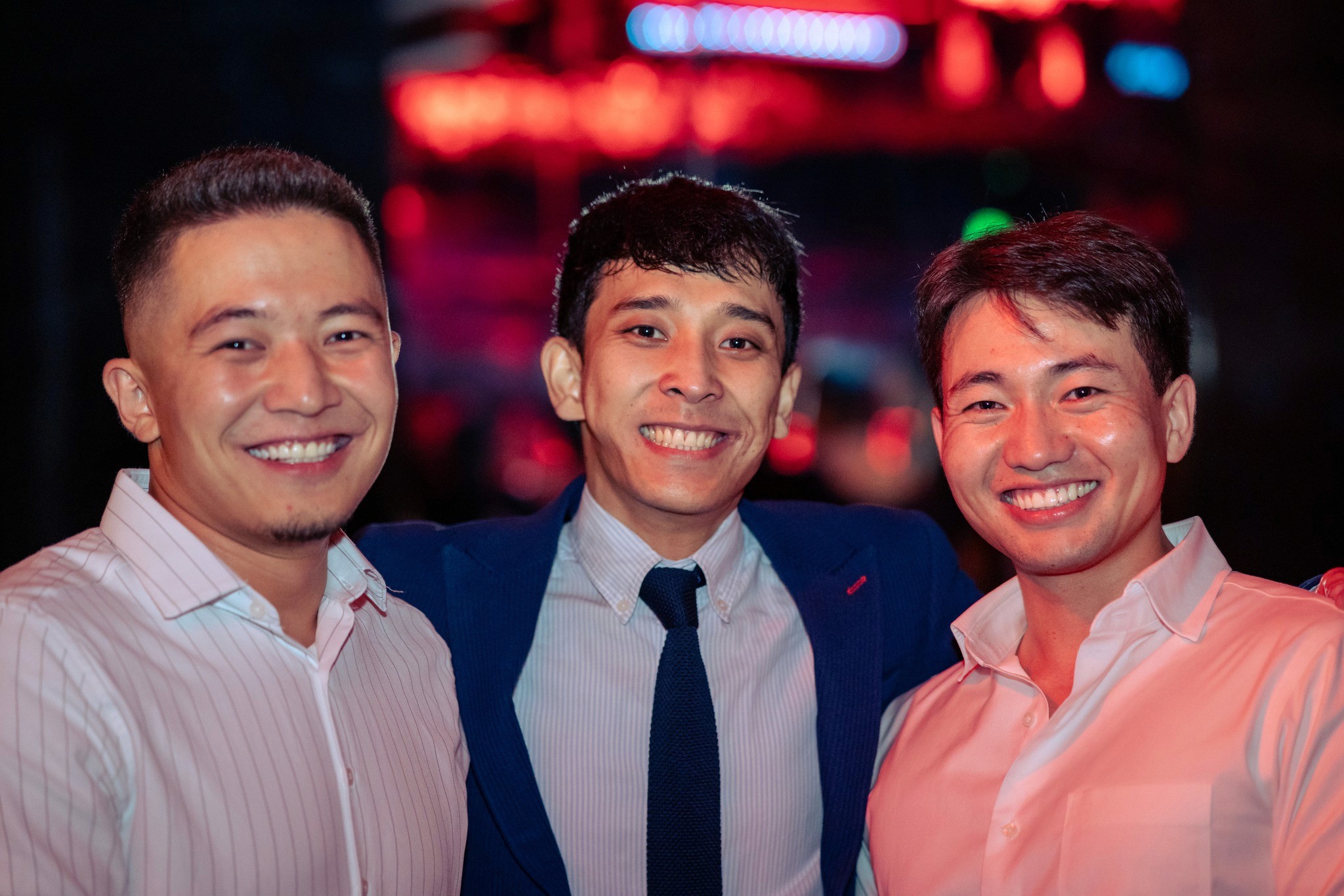 man in black crew neck t-shirt and blue shorts holding woman in white and red