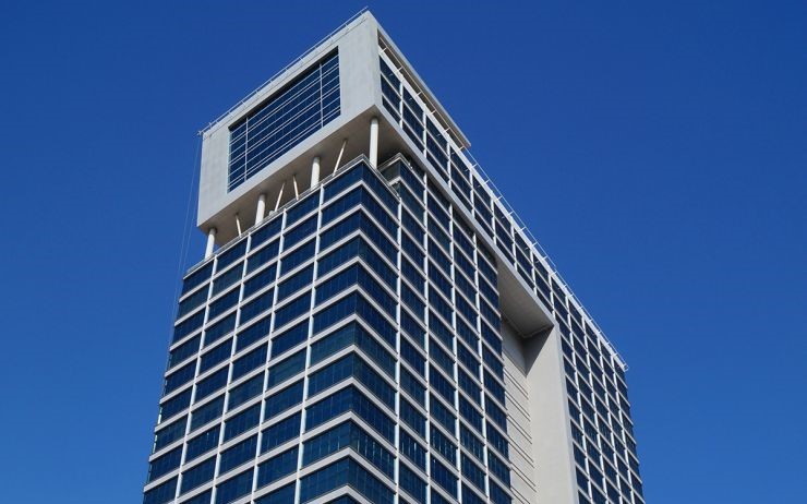 Modern architectural design of Clover Bay Tower, offering luxury corporate offices for sale and rent.