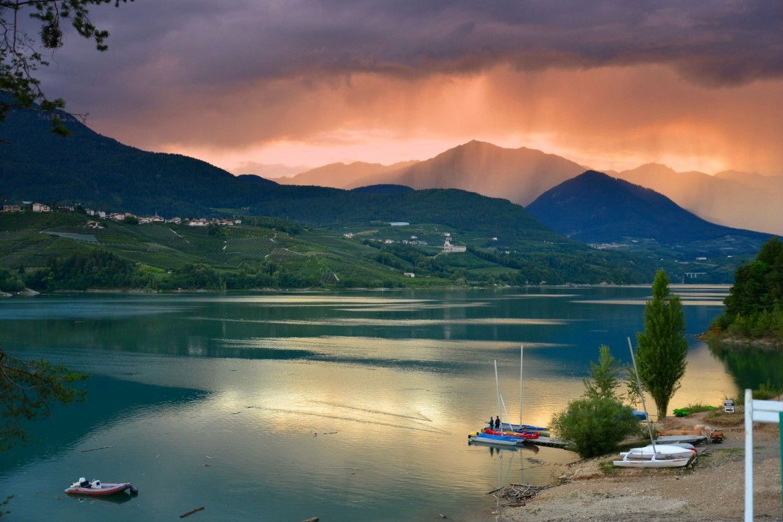 The iconic spring scenery of blooming apple orchards during a fishing trip in the Dolomites