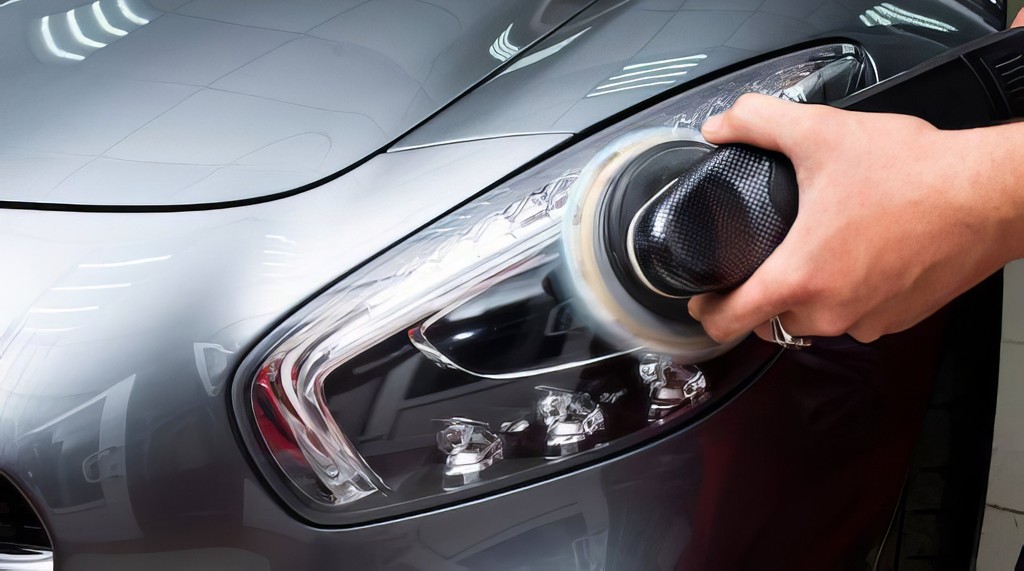 a man waxing the hood of a car
