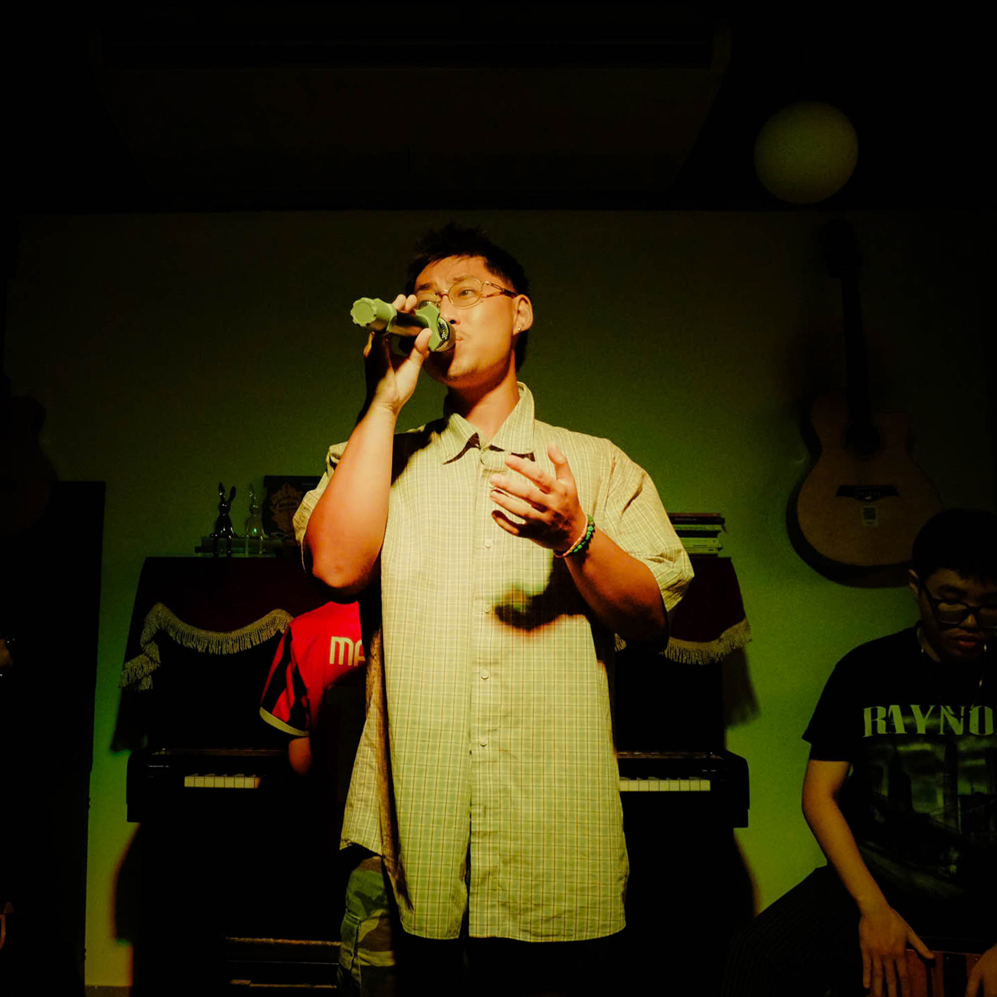 Vocalist singing inside an orange light ring effect