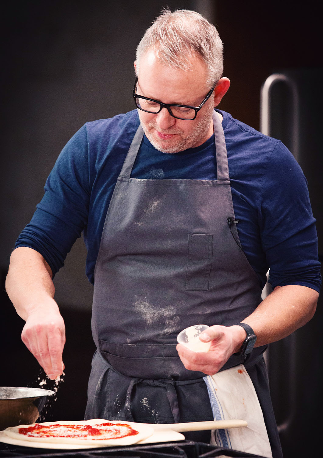 Chef Ethan Stowell prepares a handmade pizza on the studio kitchen set at Particle Studio in Seattle, WA.