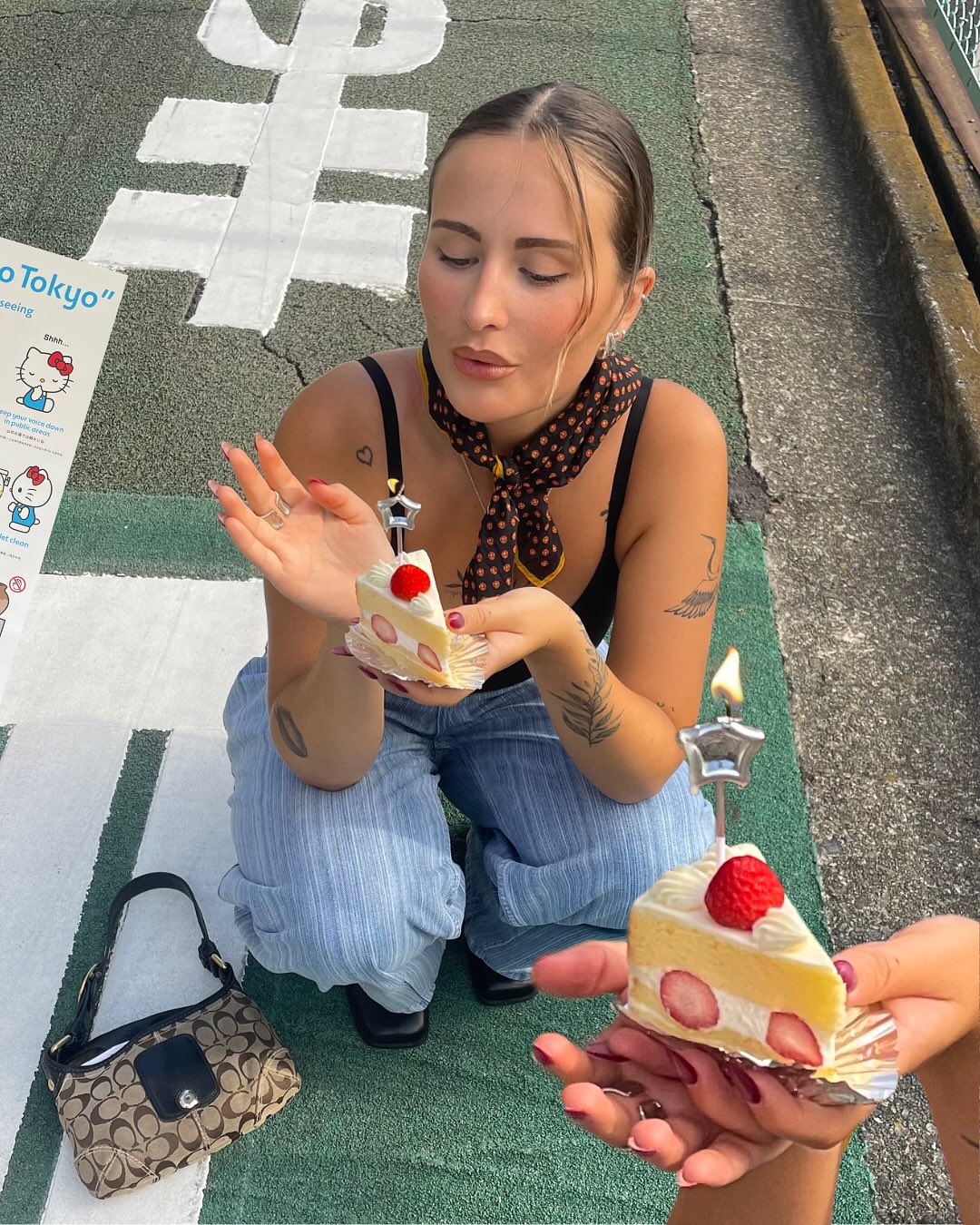 woman in a street with a cake in her hands