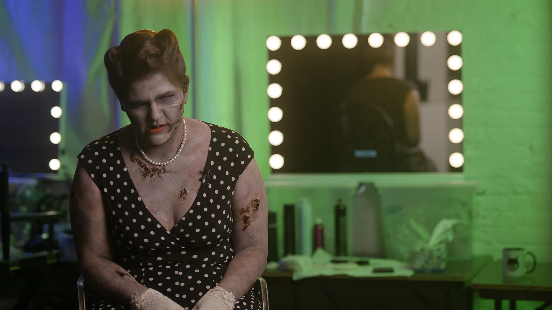 Jane Doe, zombie correspondent, in the newsroom makeup room