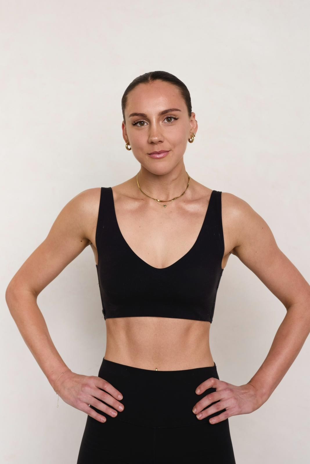 Black cosmetic product bottle against a dark background