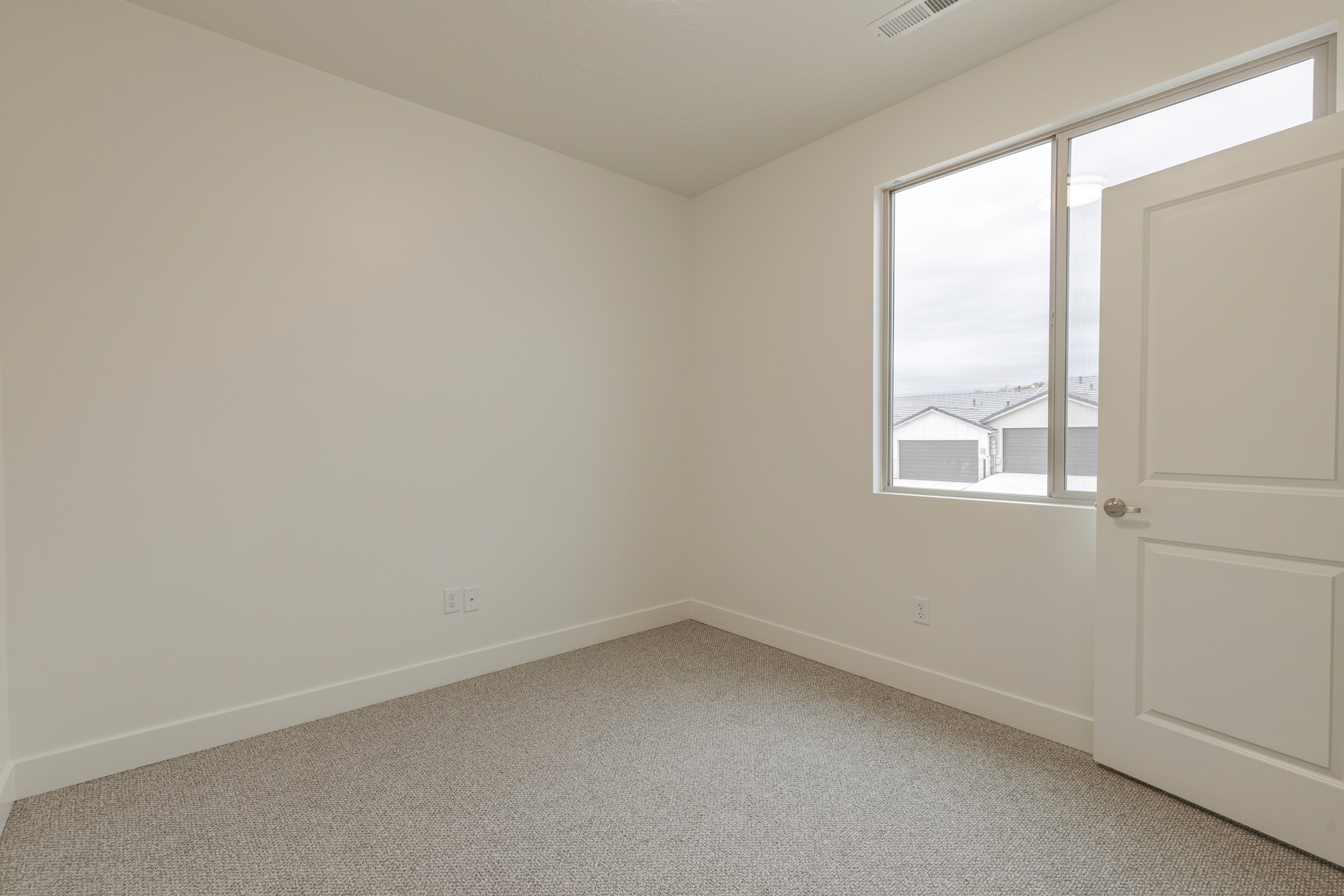 Secondary bedroom in the Painted Sands twin home in Hurricane, Utah designed for comfort and flexibility.