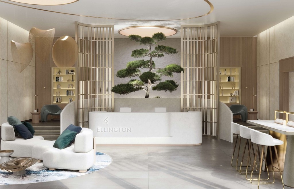 A modern office interior featuring a reception desk and chairs, showcasing The Crestmark branding.