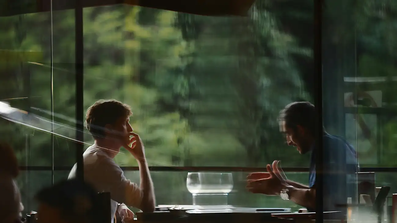 Two people having a focused conversation in a meeting room, representing sponsorship meeting preparation, Q&A planning and handling sponsor questions for sports clubs.