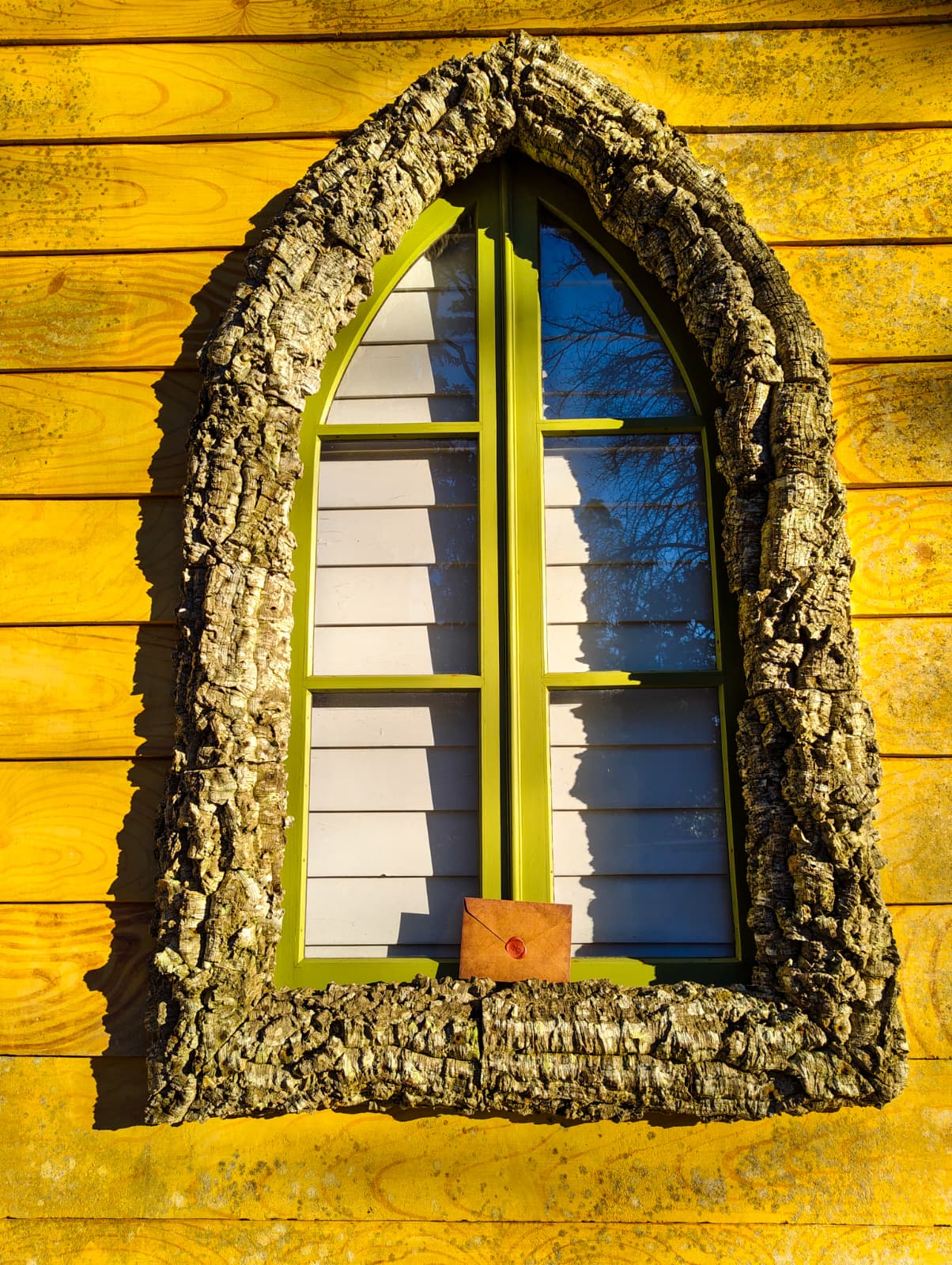 A young woman with wet hair, leaning back in a bath with her eyes closed. The sunlight reflects off the water, creating a serene and tranquil atmosphere.
