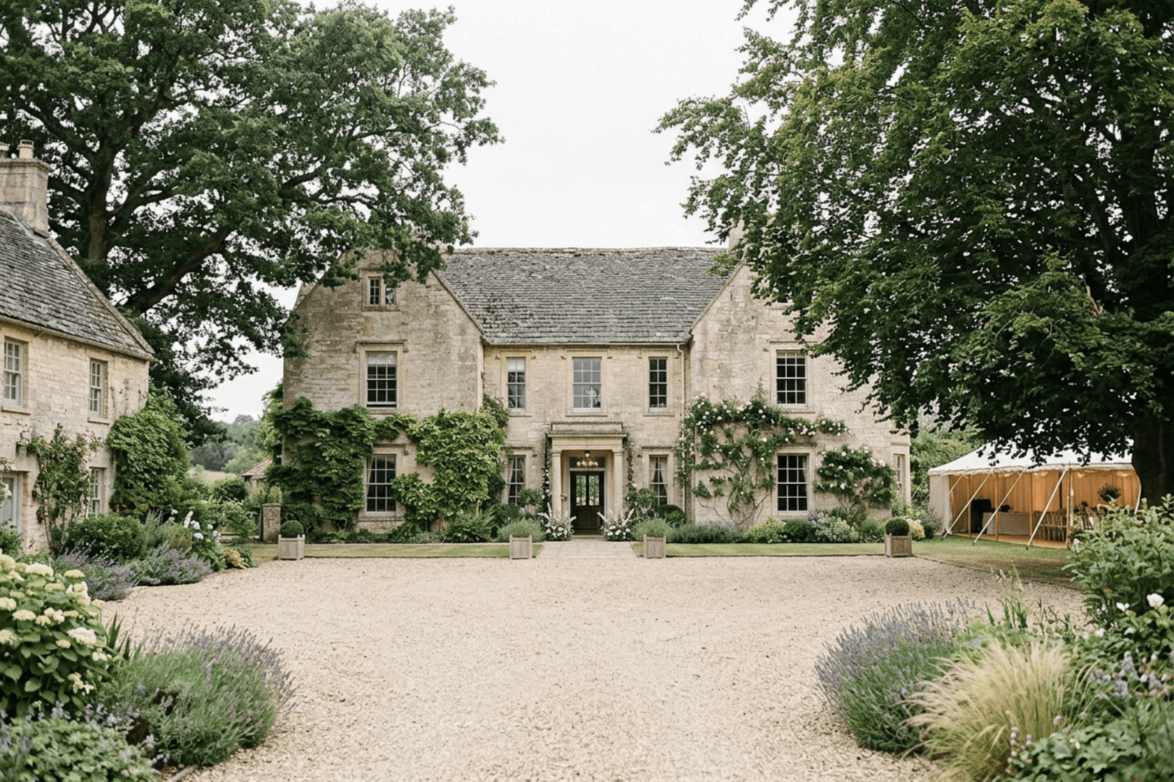 Limestone country house framed by trees