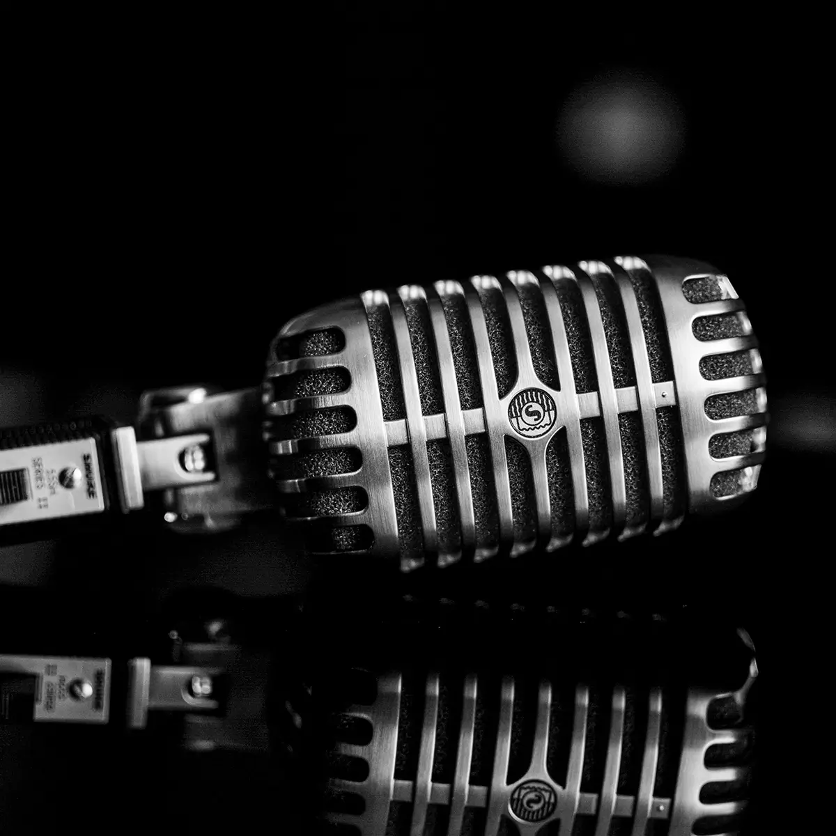 picture of a vintage sennheiser metal microphone tilted on its side