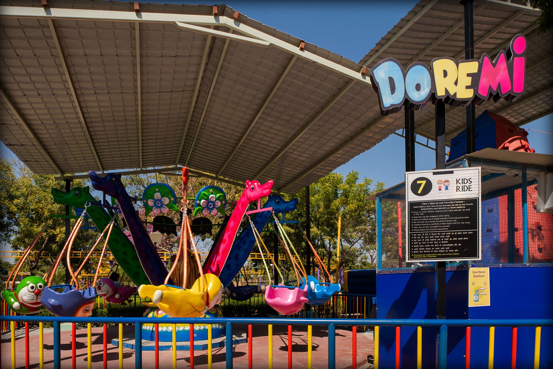 Sunlit orange armchair beside sheer curtains, wooden floor.
