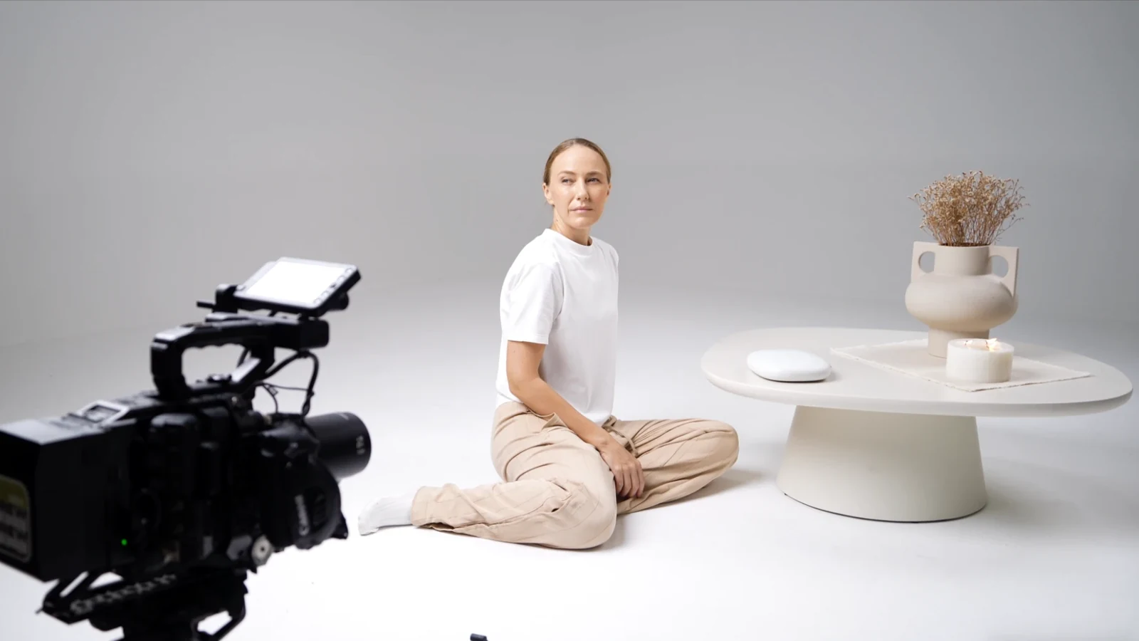 Model on the white cyclorama set with the cinema camera in the foreground