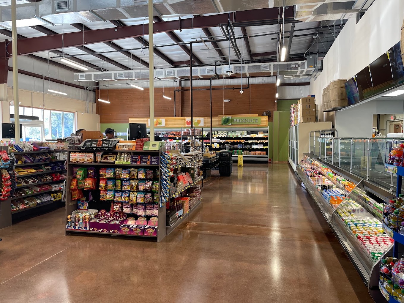 Wide view of the International Food Market Orlando interior, highlighting the spacious grocery aisles, fresh produce, and halal meat section for a complete shopping experience.