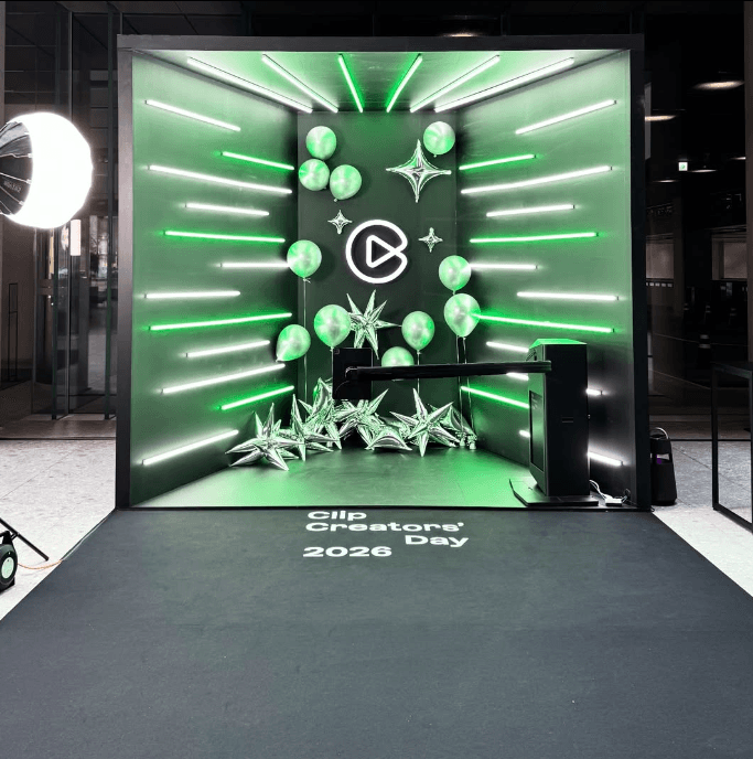 Cluster of translucent pink glass pendant spheres hanging on white—modern lighting décor.