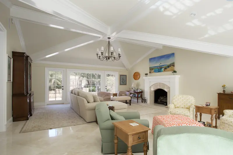 Spacious living room with vaulted ceiling and large fireplace from the Big Canyon Remodel project. Photo by Chris Darnall.