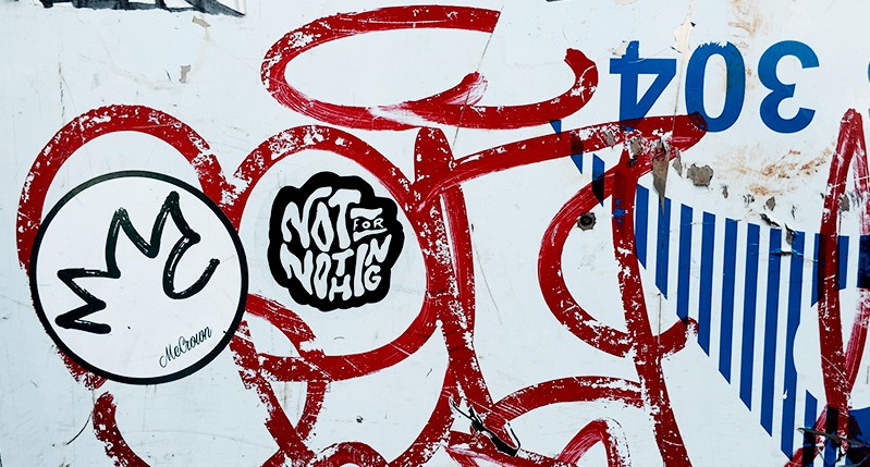 sticker on grafitti wall