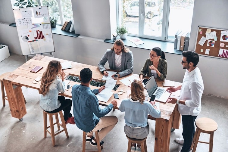 Group of members working together on a large table