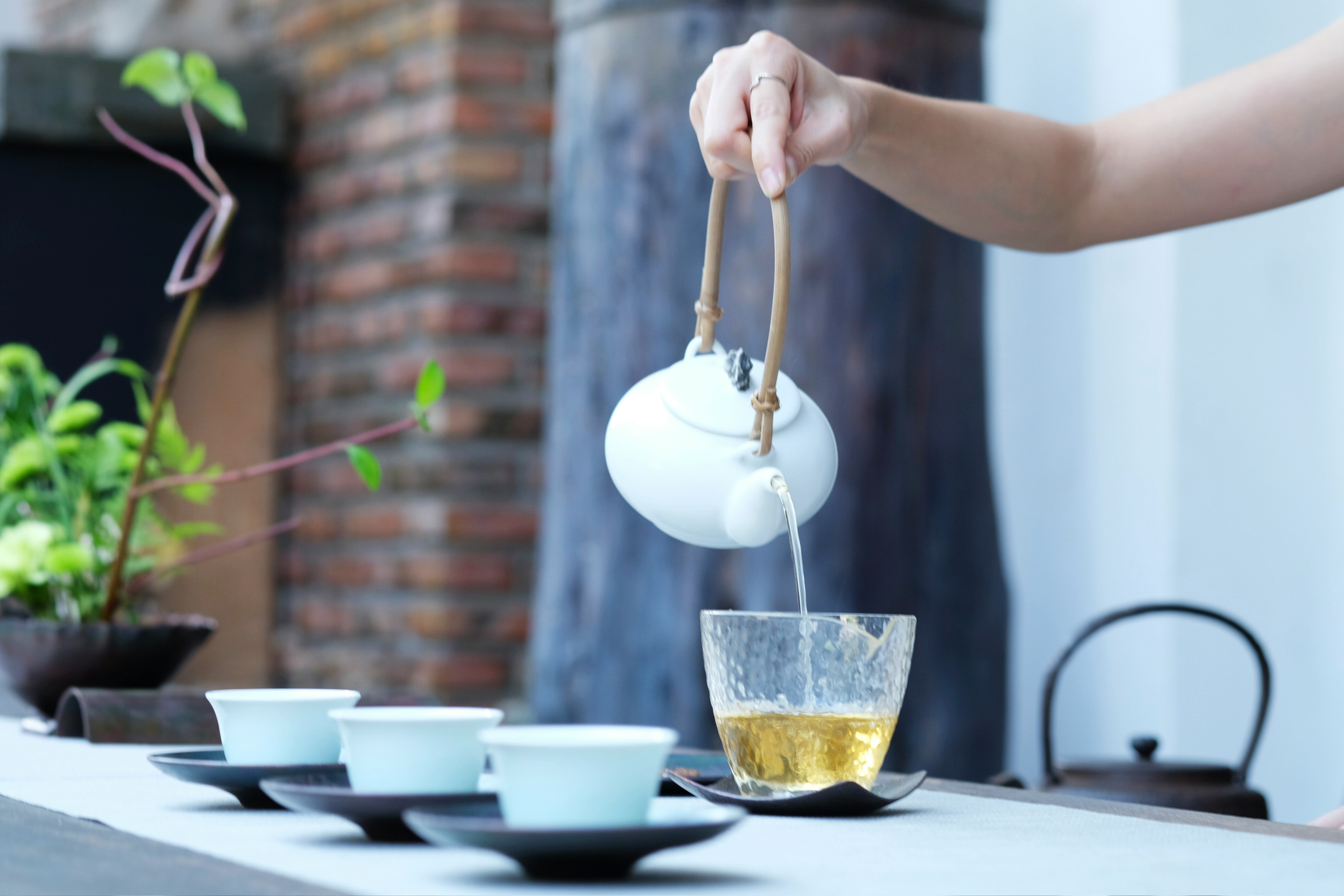 a person serving a cup of tea