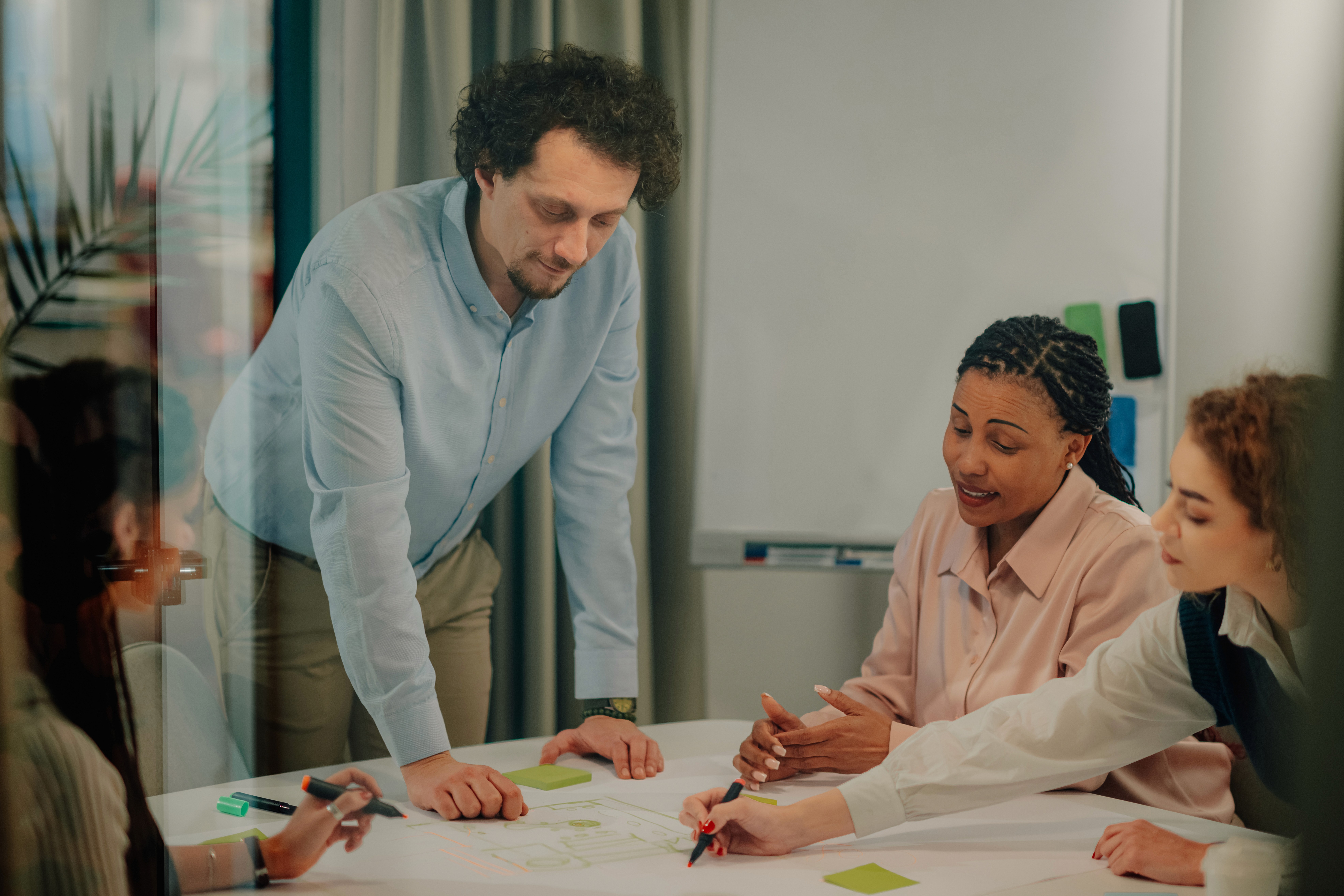 Person smiling while working on a laptop, with icons representing AI-powered research tools around