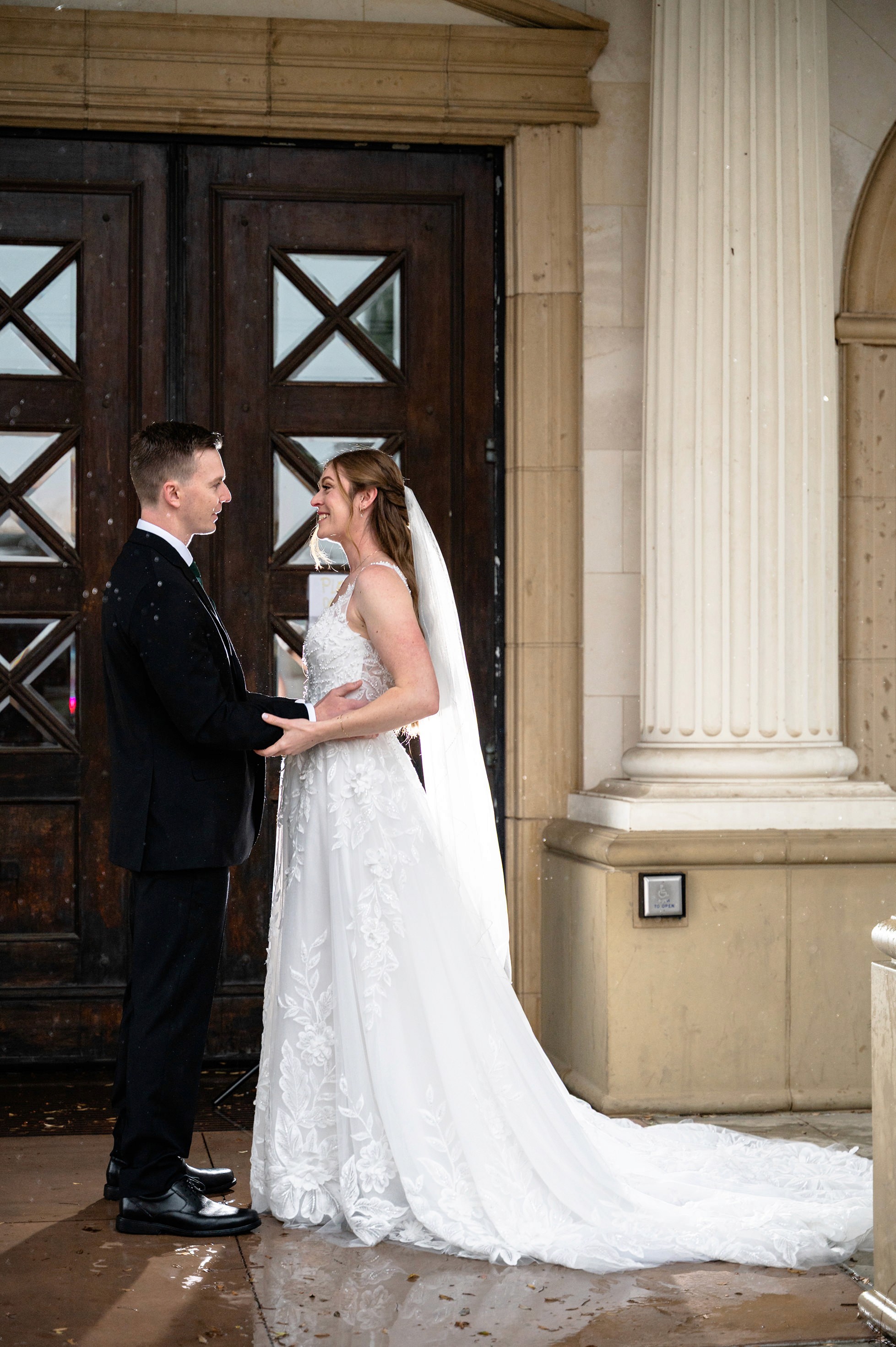 Flat lay wedding details with bouquet, rings, and sparkling bridal heels