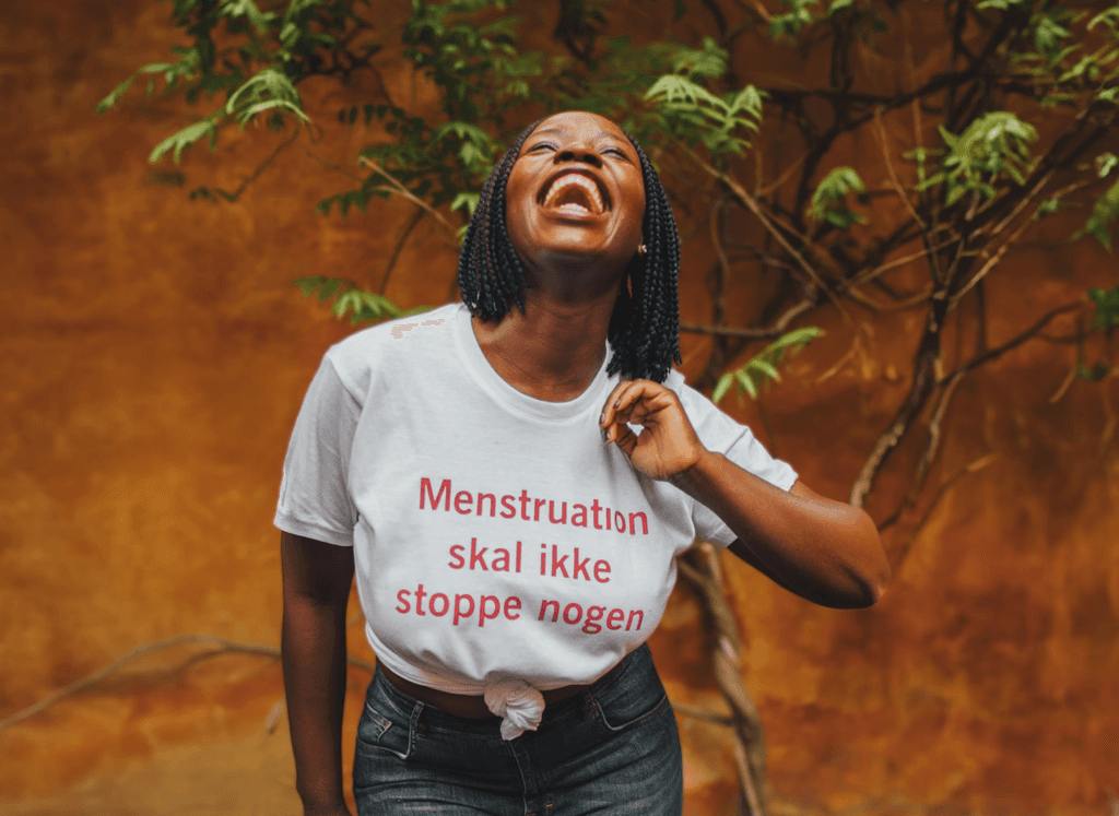 Mary wearing a t-shirt with the text 'Menstruation should not stop anyone'