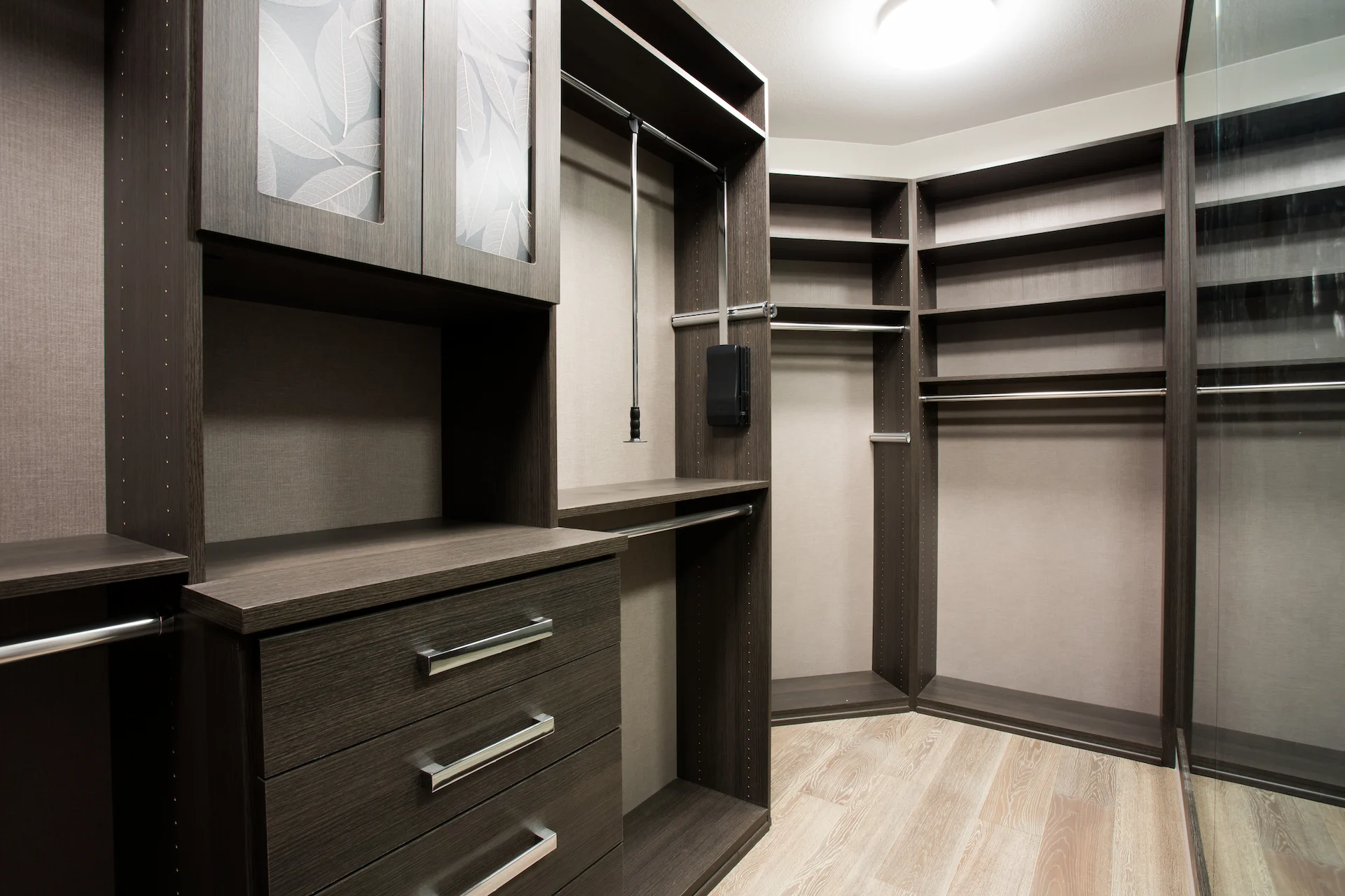 View of the spacious master walk-in closet, offering ample storage and sophisticated design in this contemporary Newport Beach home.