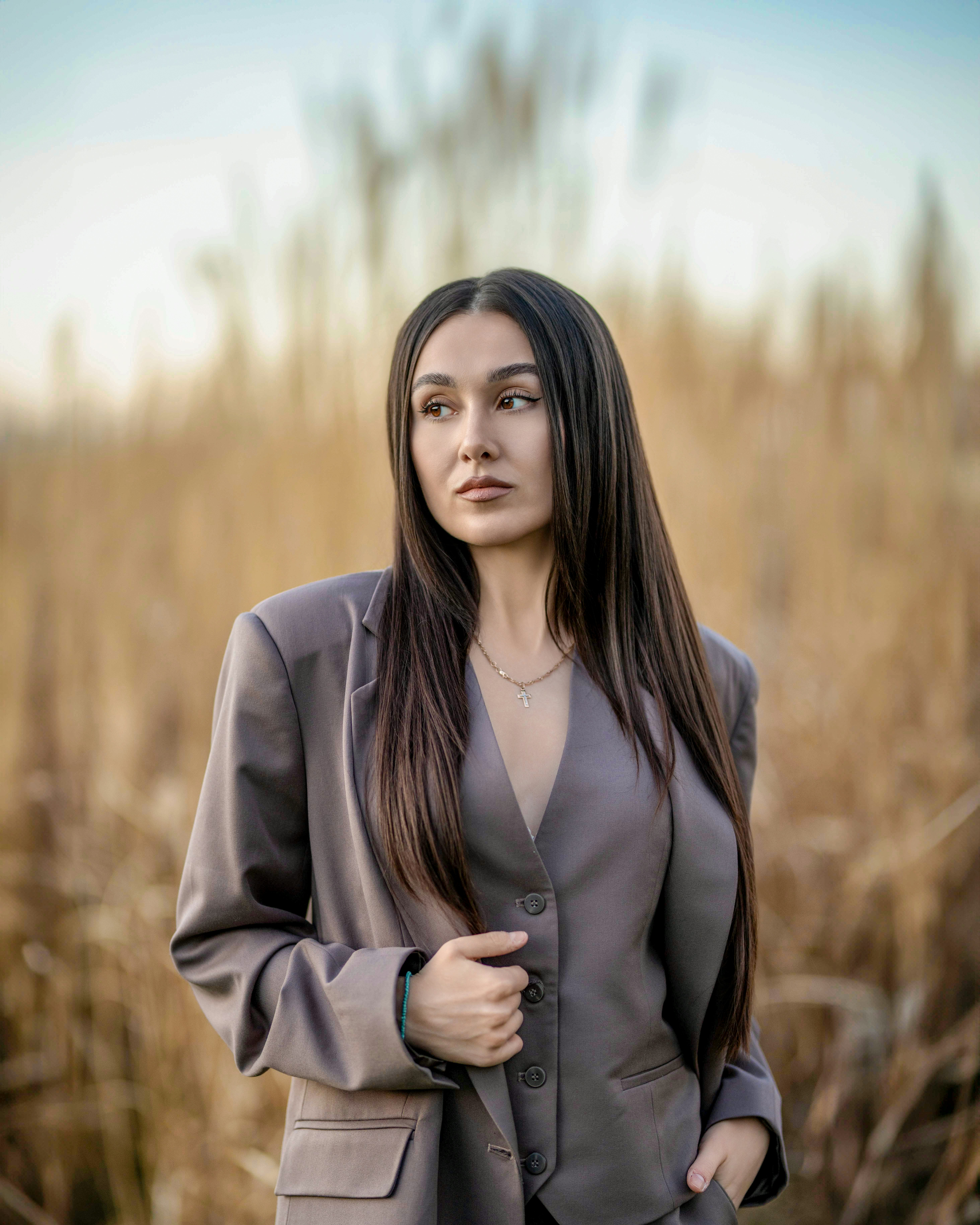 a woman standing in a field of tall grass