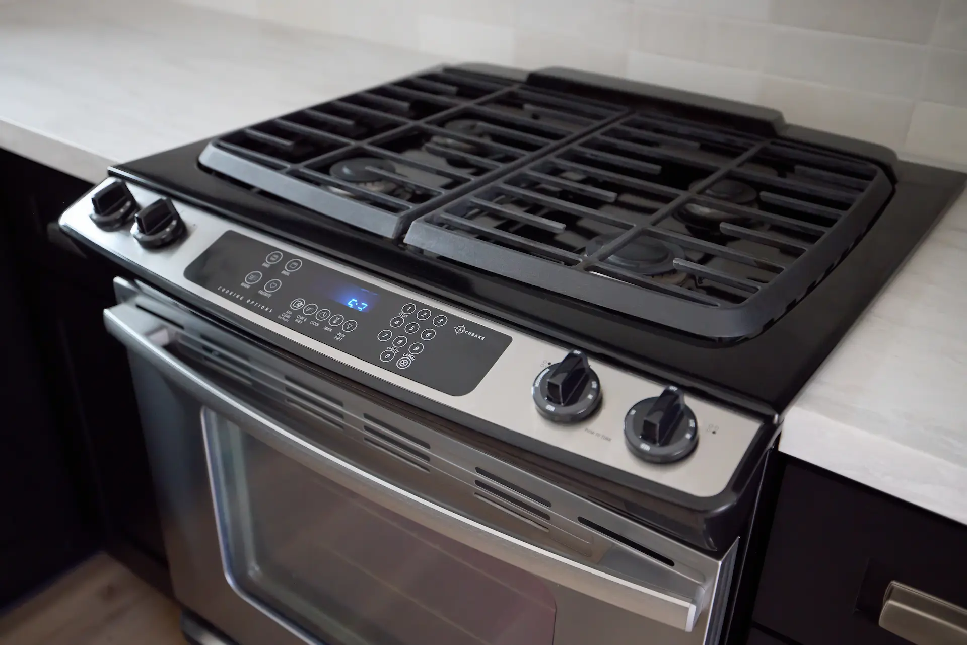 Close-up of the oven and range in ADU Orange, where modern appliances enhance the functionality of the historically inspired kitchen. Photo by Todd Huge
