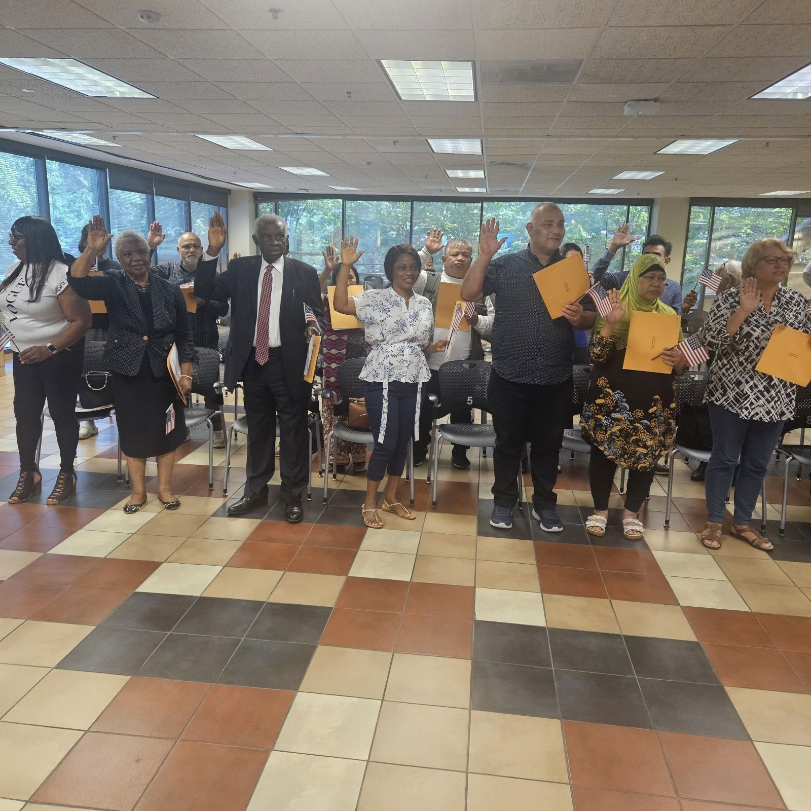Ecstatic individual holding U.S. flag after naturalization, aided by Fibi Law