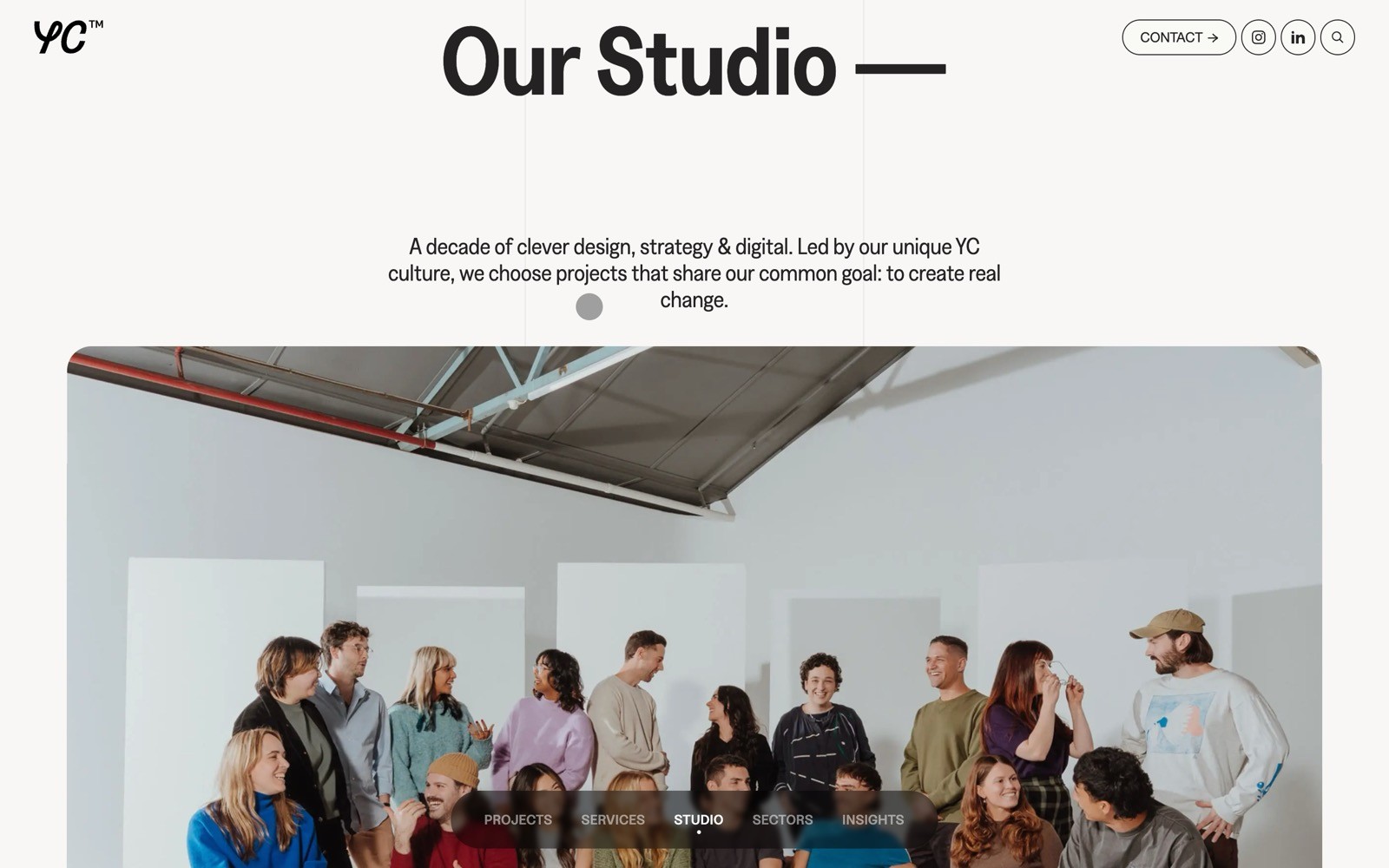 Group of people in a studio setting, sitting and standing, casually interacting. Text: "Our Studio," "A decade of clever design...