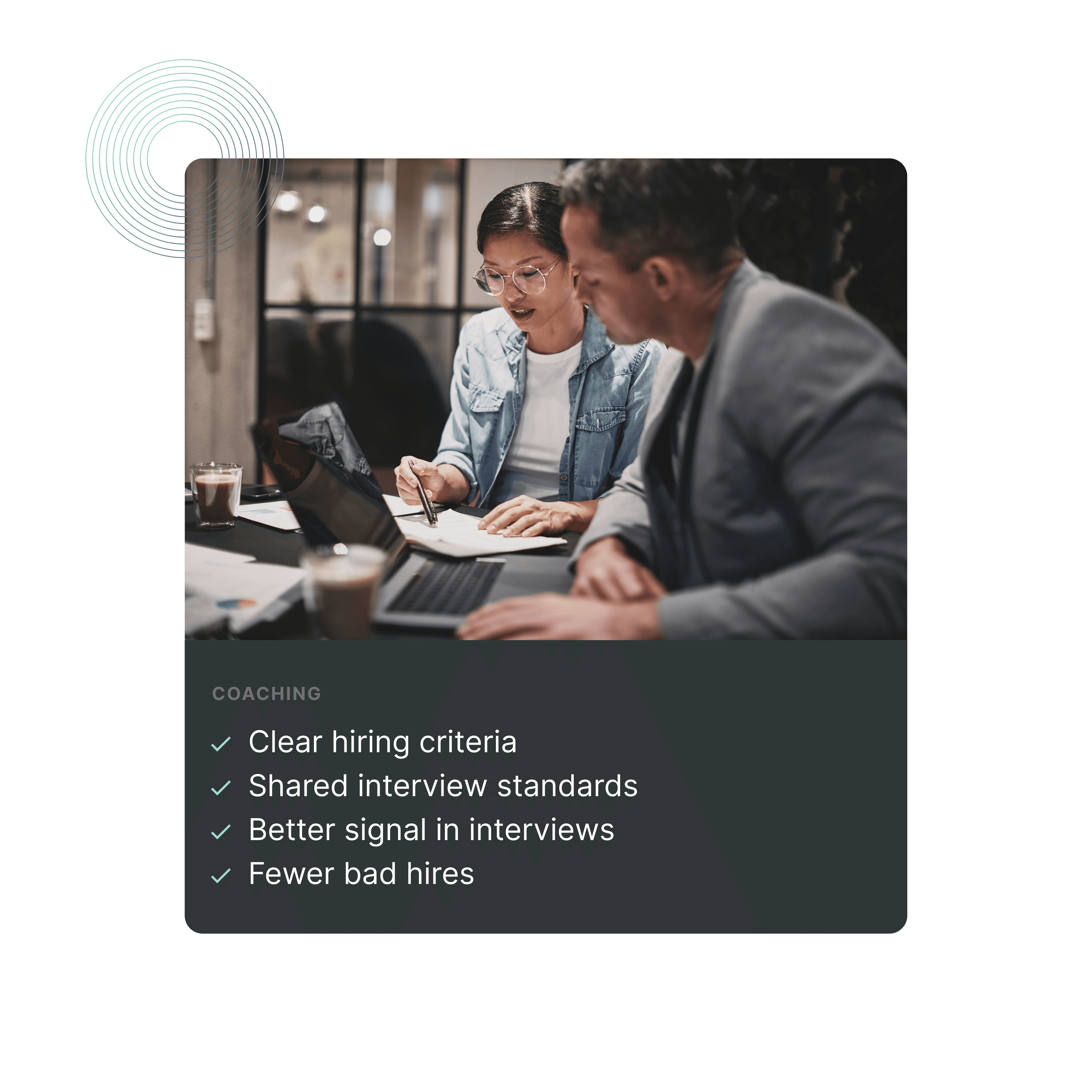 Two people collaborating at a desk, reviewing documents and discussing. Notes and a calculator visible.