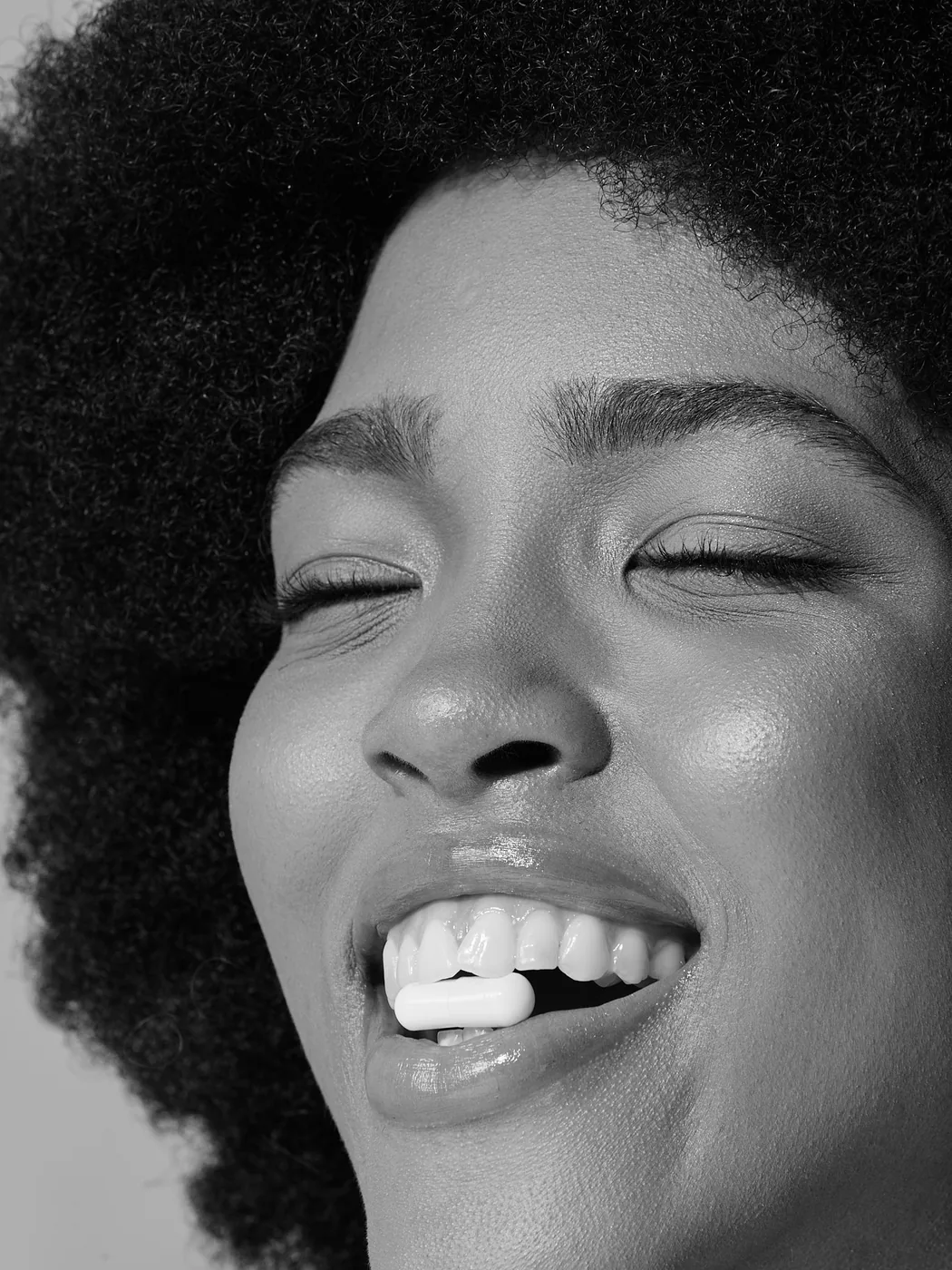 A woman laughing, close up in black and white