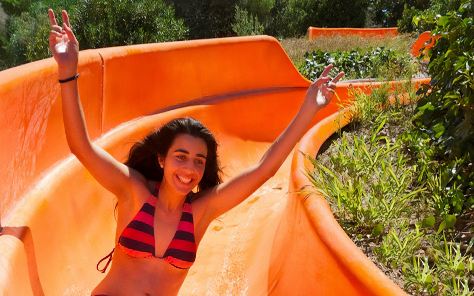 Person enjoying a water slide at Aquopolis Cullera.