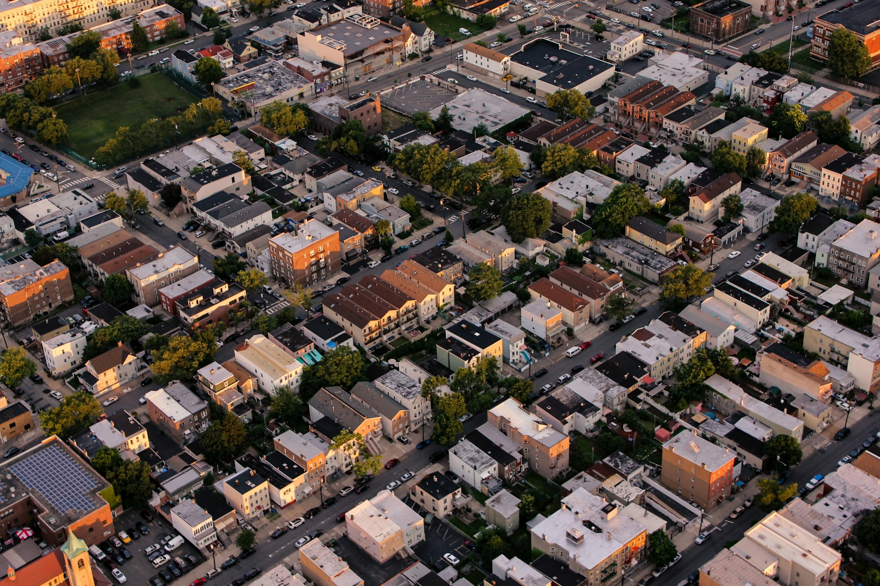 Aerial view of dense urban housing and streets.