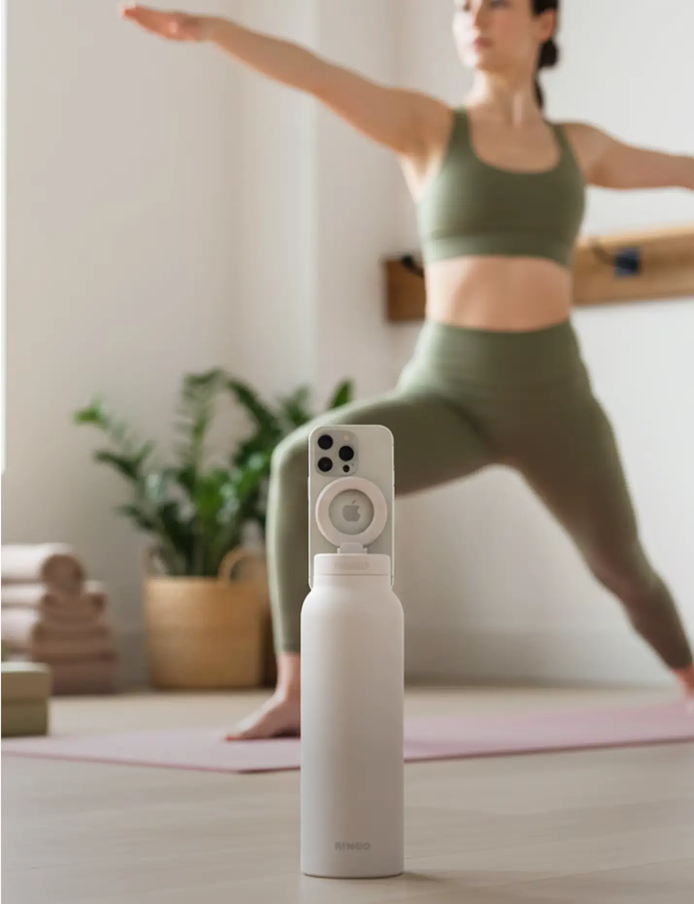 someone doing yoga with their ringo water bottle facing them