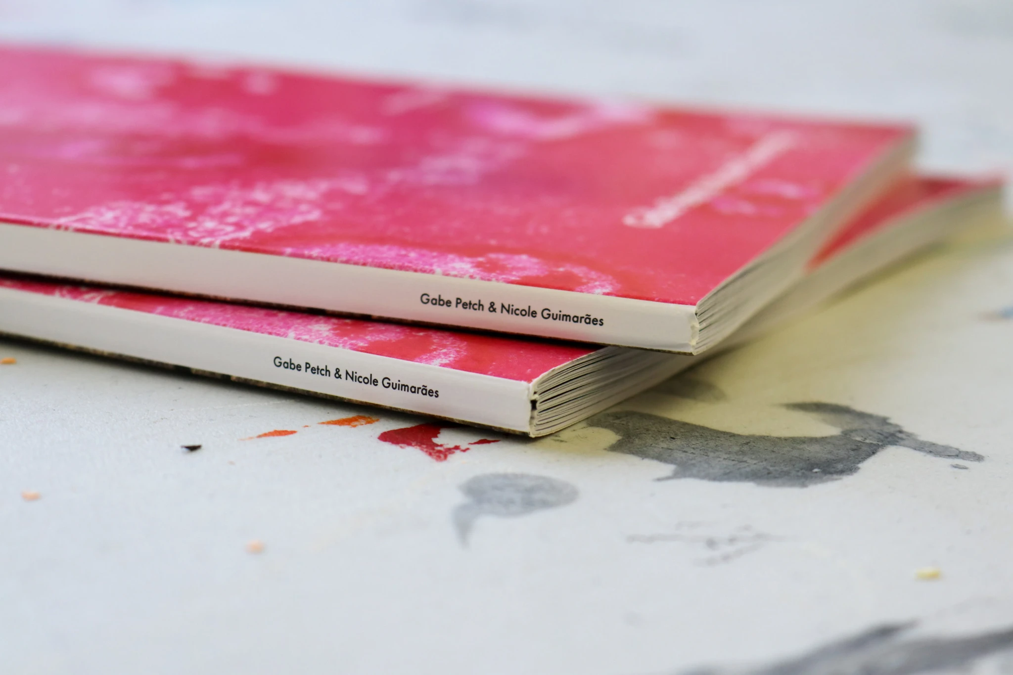 Stack of On Creativ-ity journals, pink covers close up