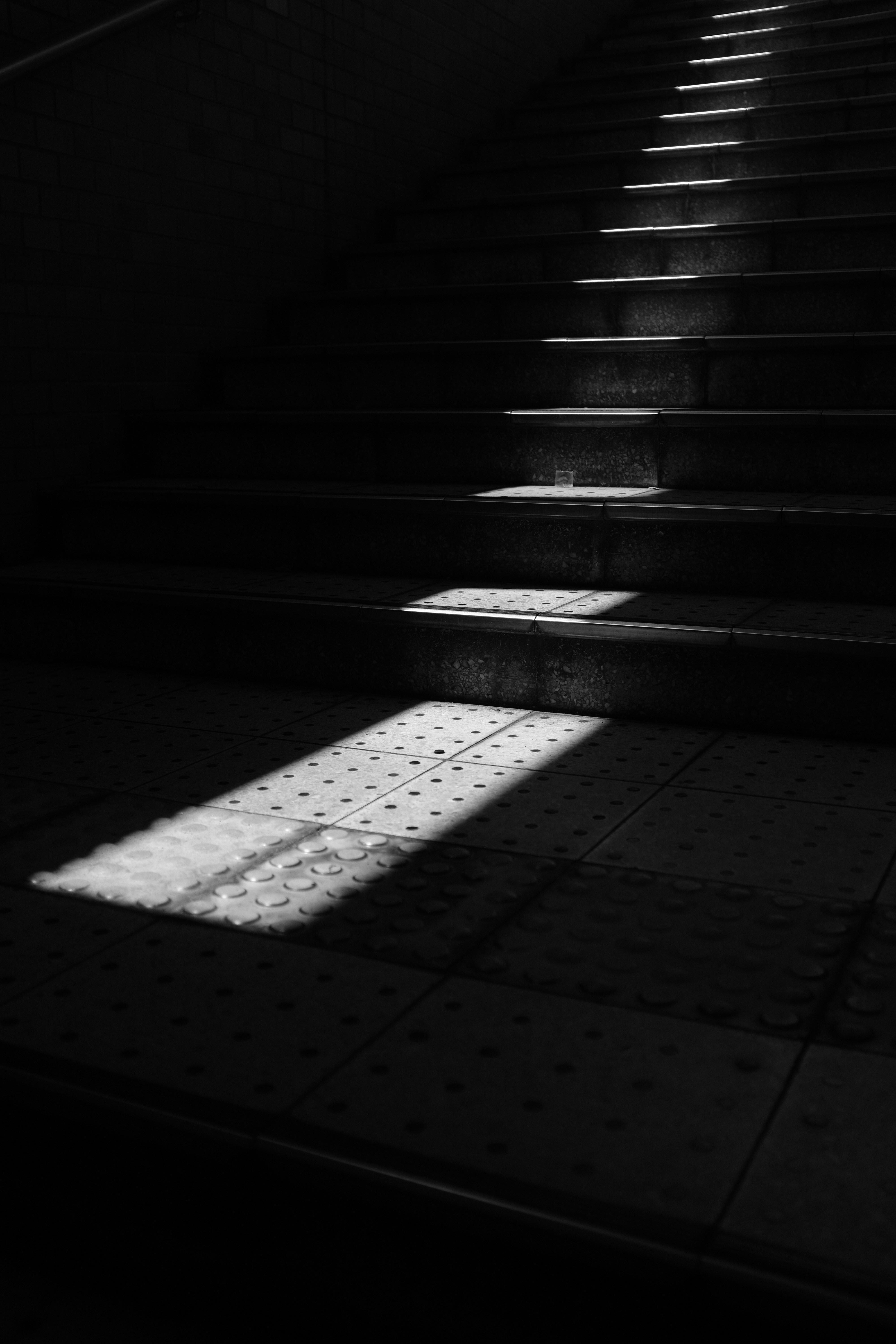 light shining down a dark staircase