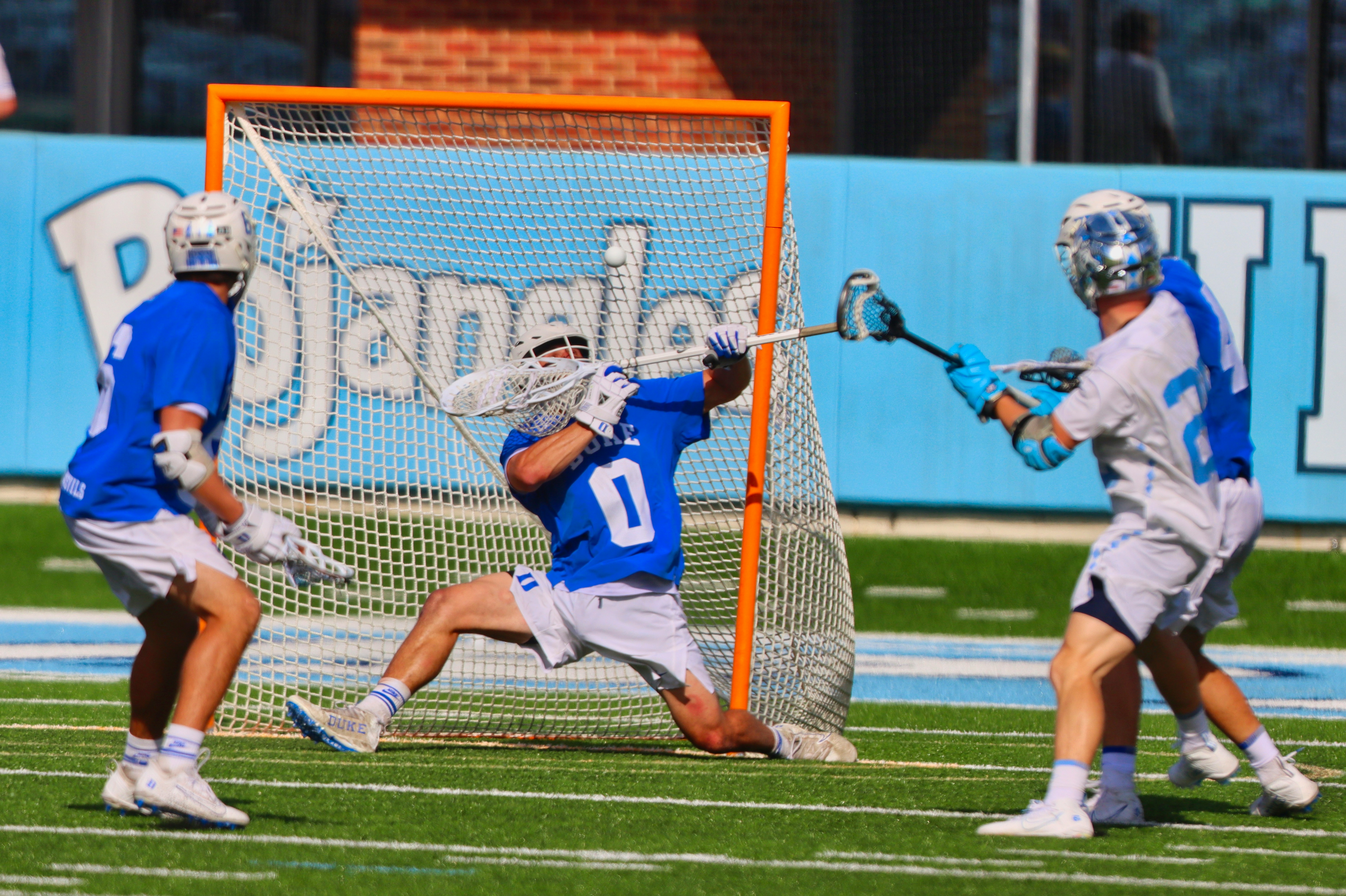 players are defending in a game of lacrosse resulting in injury