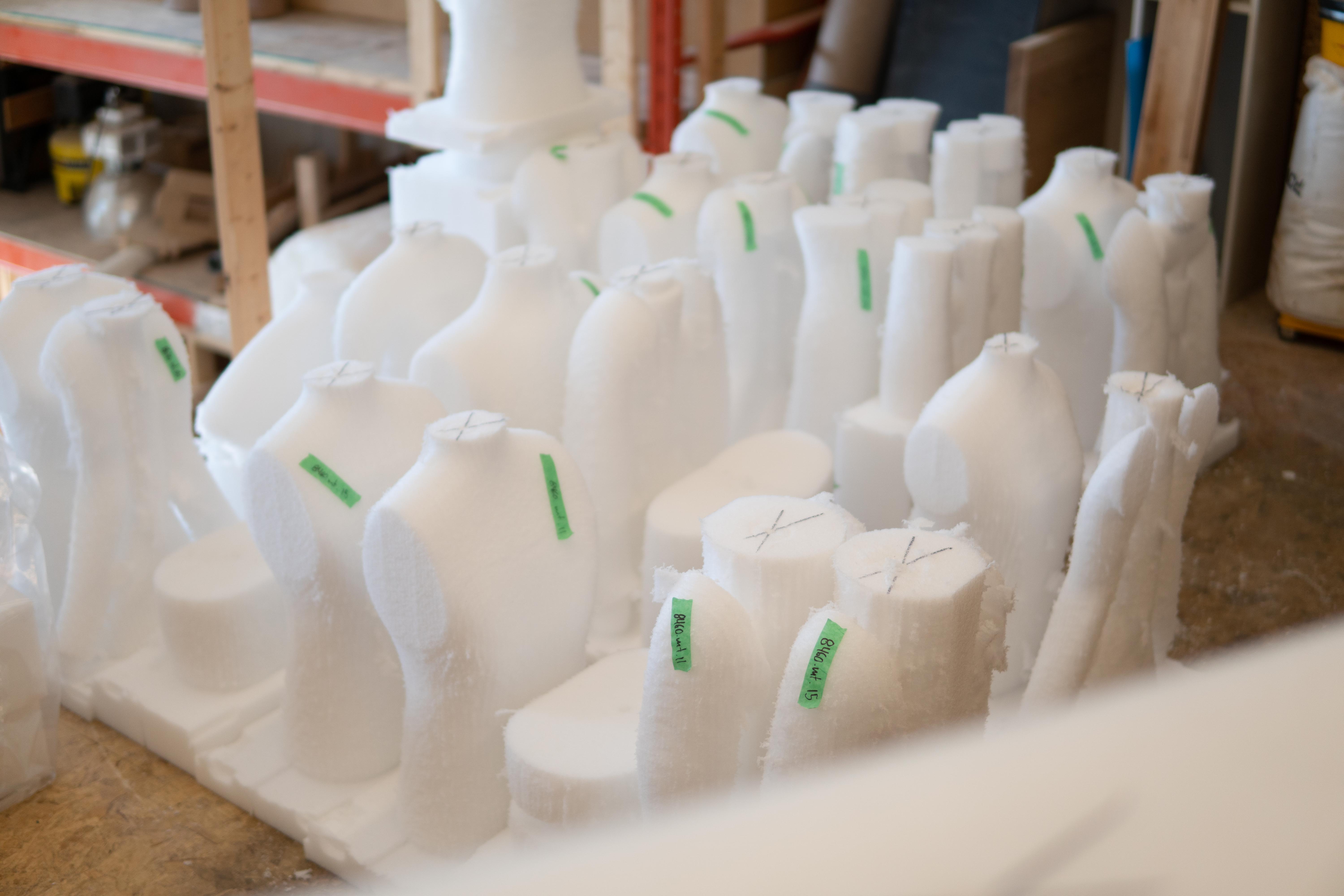 mannequin's that have been made sitting on the floor waiting to be put together