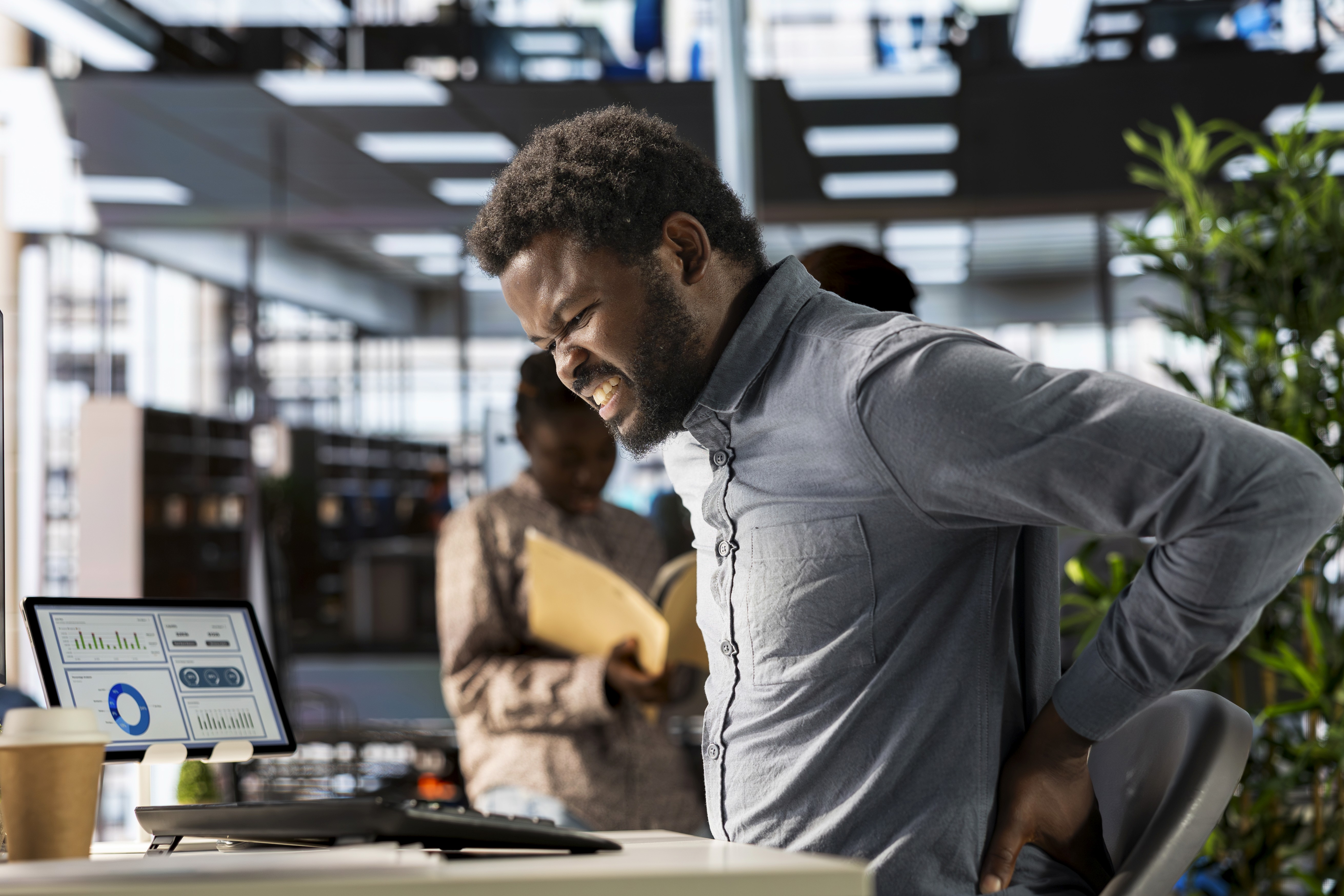 Doctor holding X-Ray discussing medical treatment in hospital office