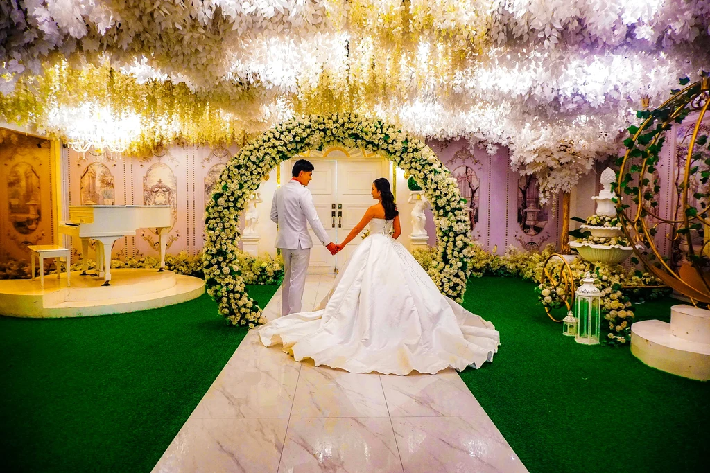 Couple exchanging a moment under the garden arch at Celestia Hall, Stalla Suites Events Place